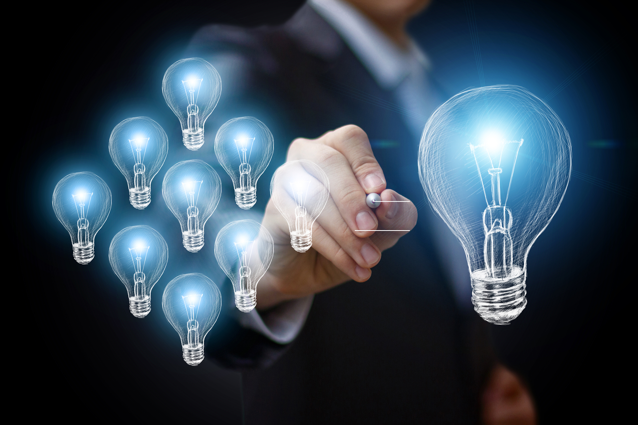 businessman draws a light bulb.