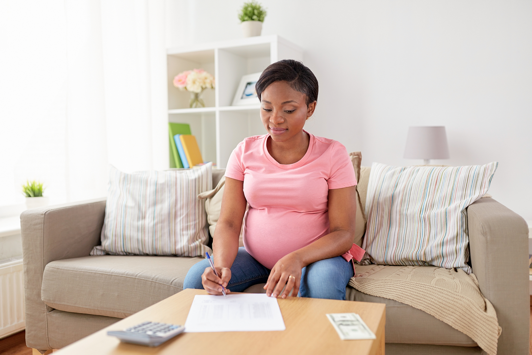 finances, pregnancy and people concept - pregnant african americ