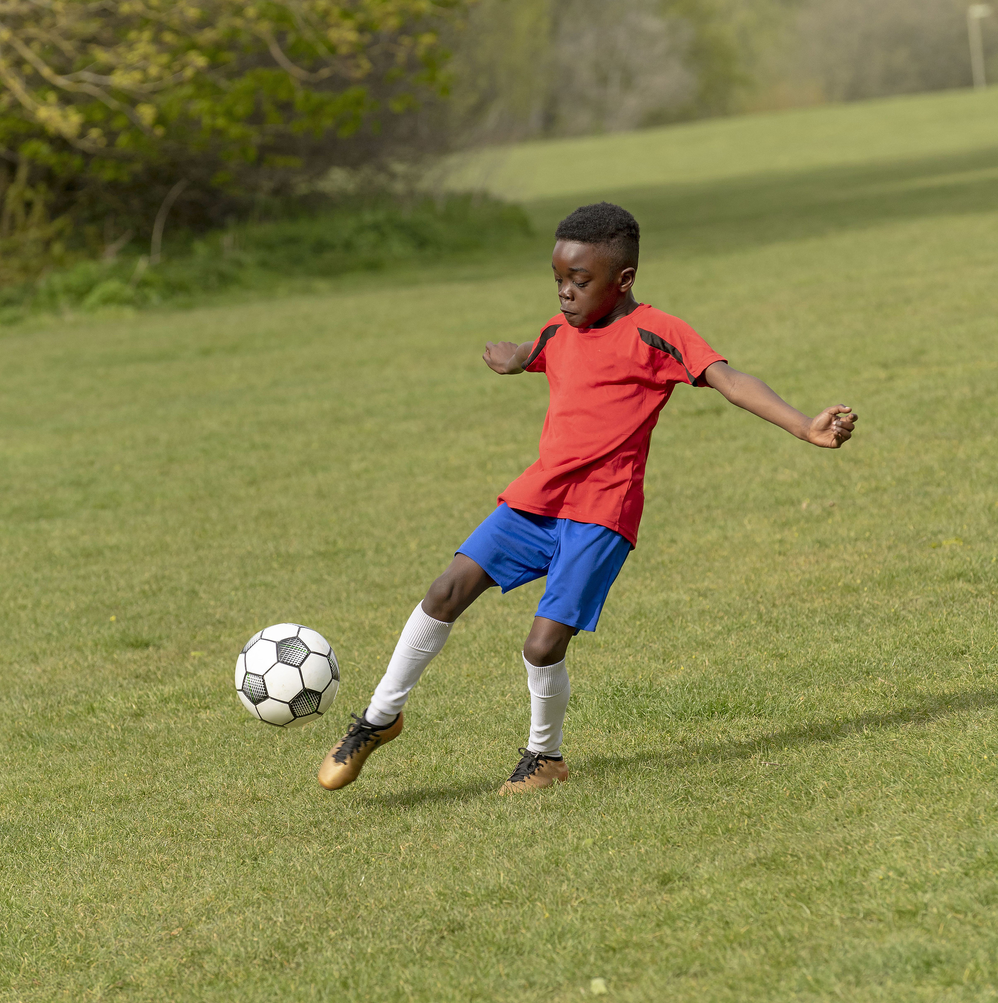 hampshire, england, uk, a nine year old footballer dribbles the 