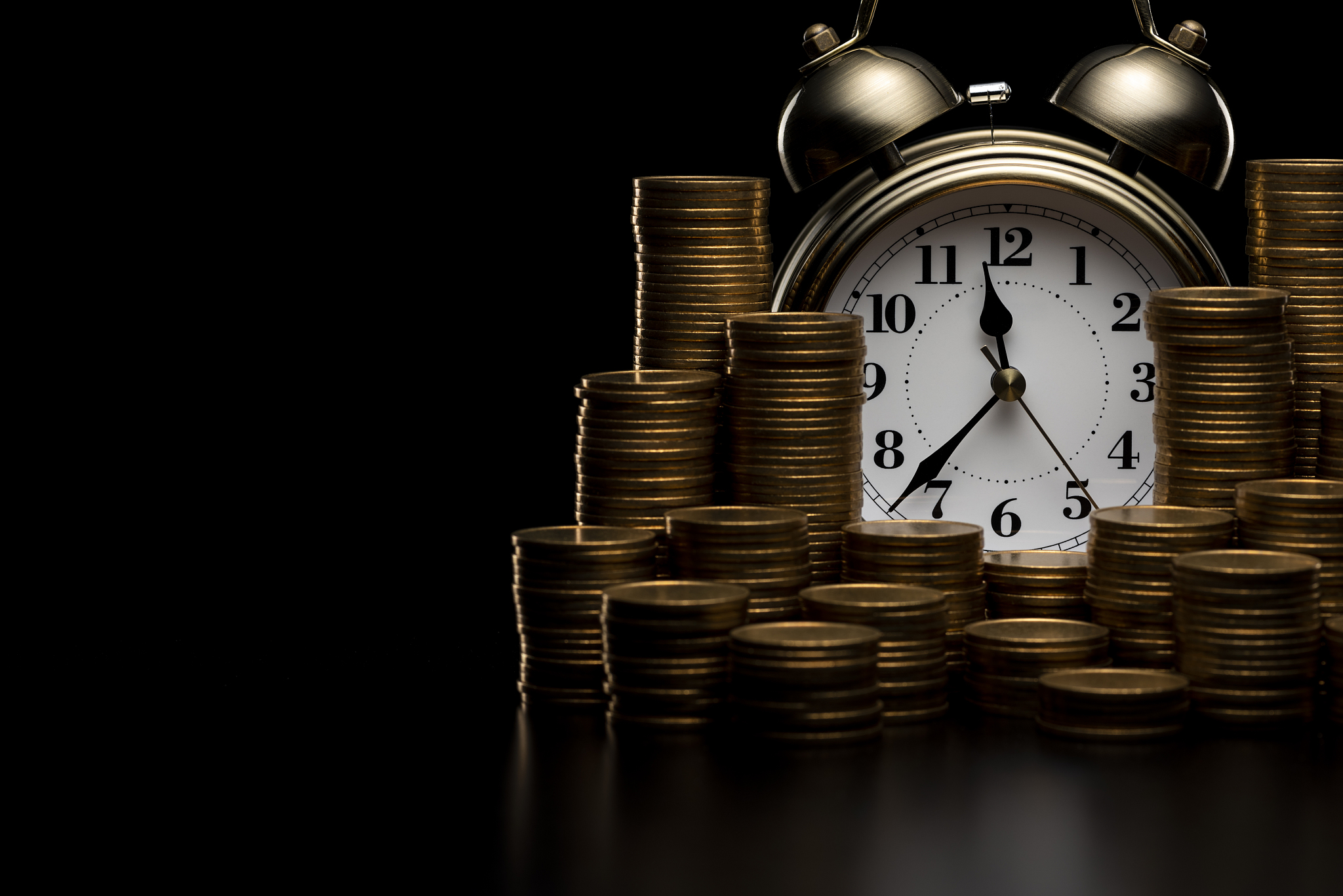 pile of coins and alarm clock.