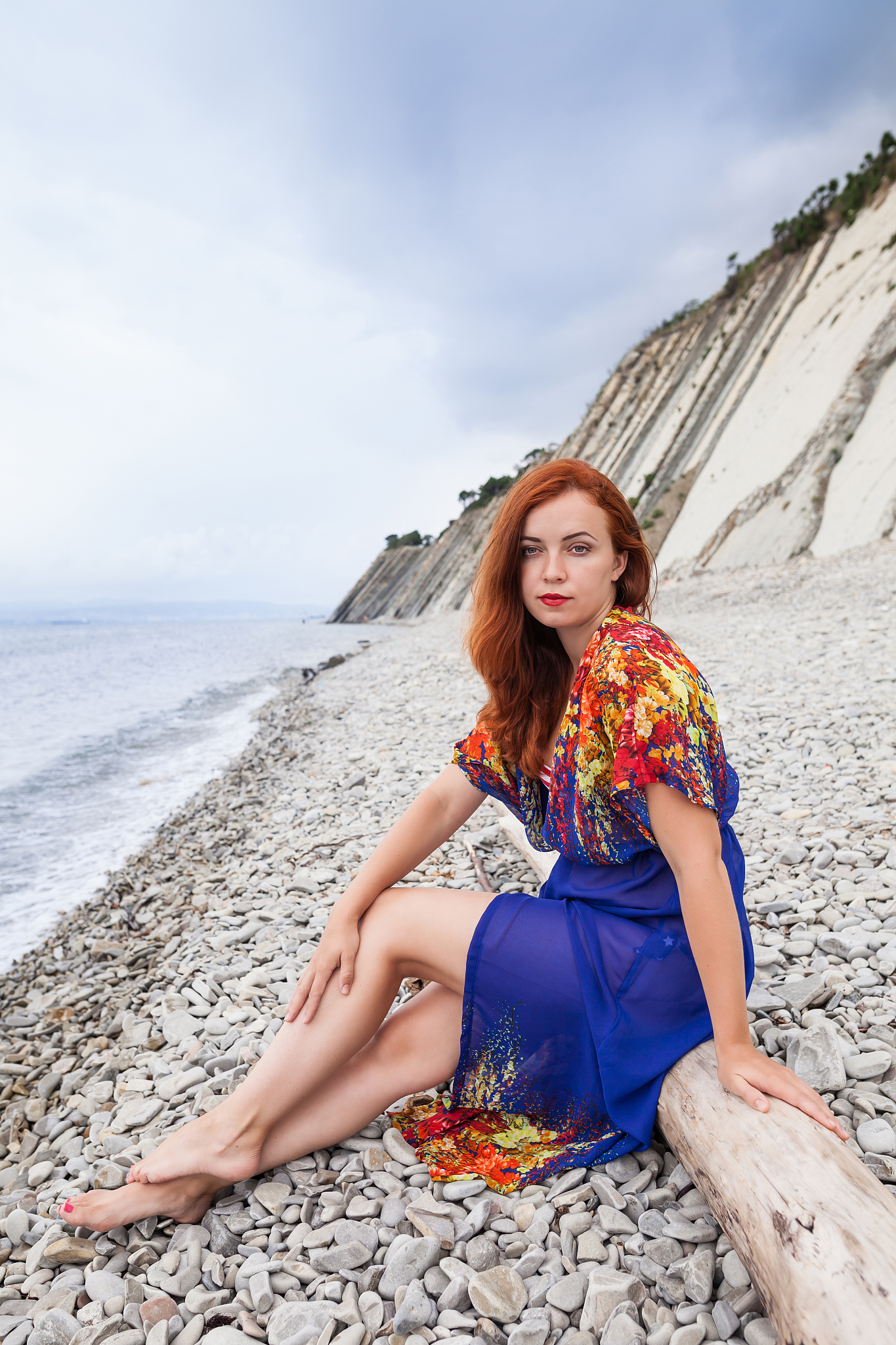 young woman on the stone beach