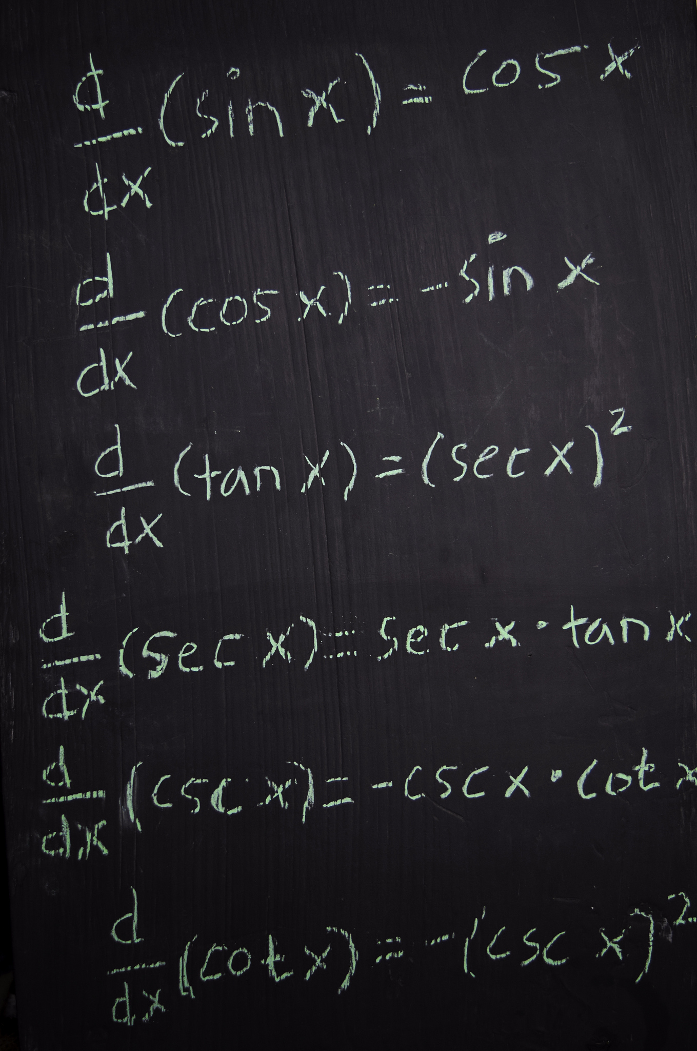 close up math formulas written on a blackboard. education concep