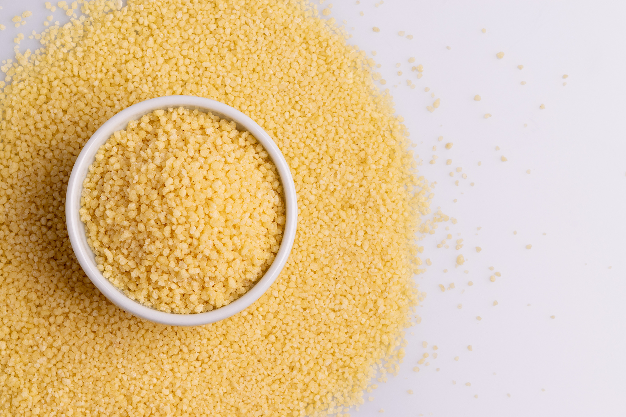 dry couscous isolated on white background, soft light, copy spac
