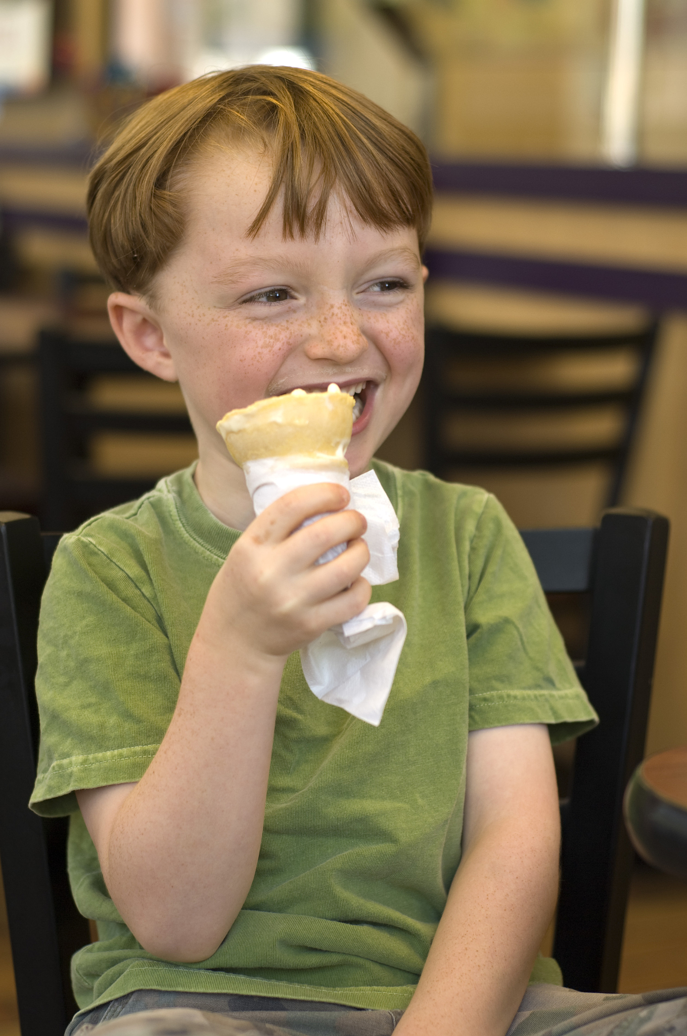 boy laughing in parlor restaurant & child eating ice cream cone
