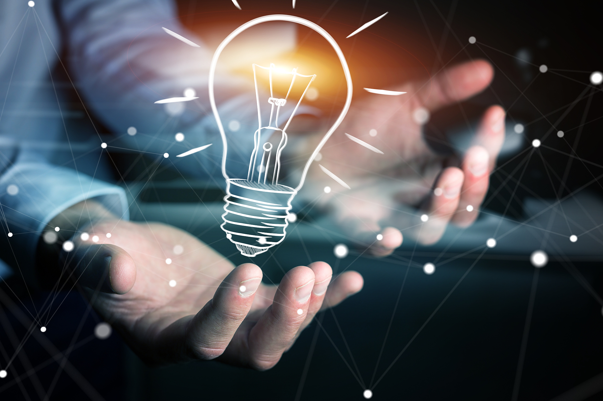 businessman holding a sketch lightbulb