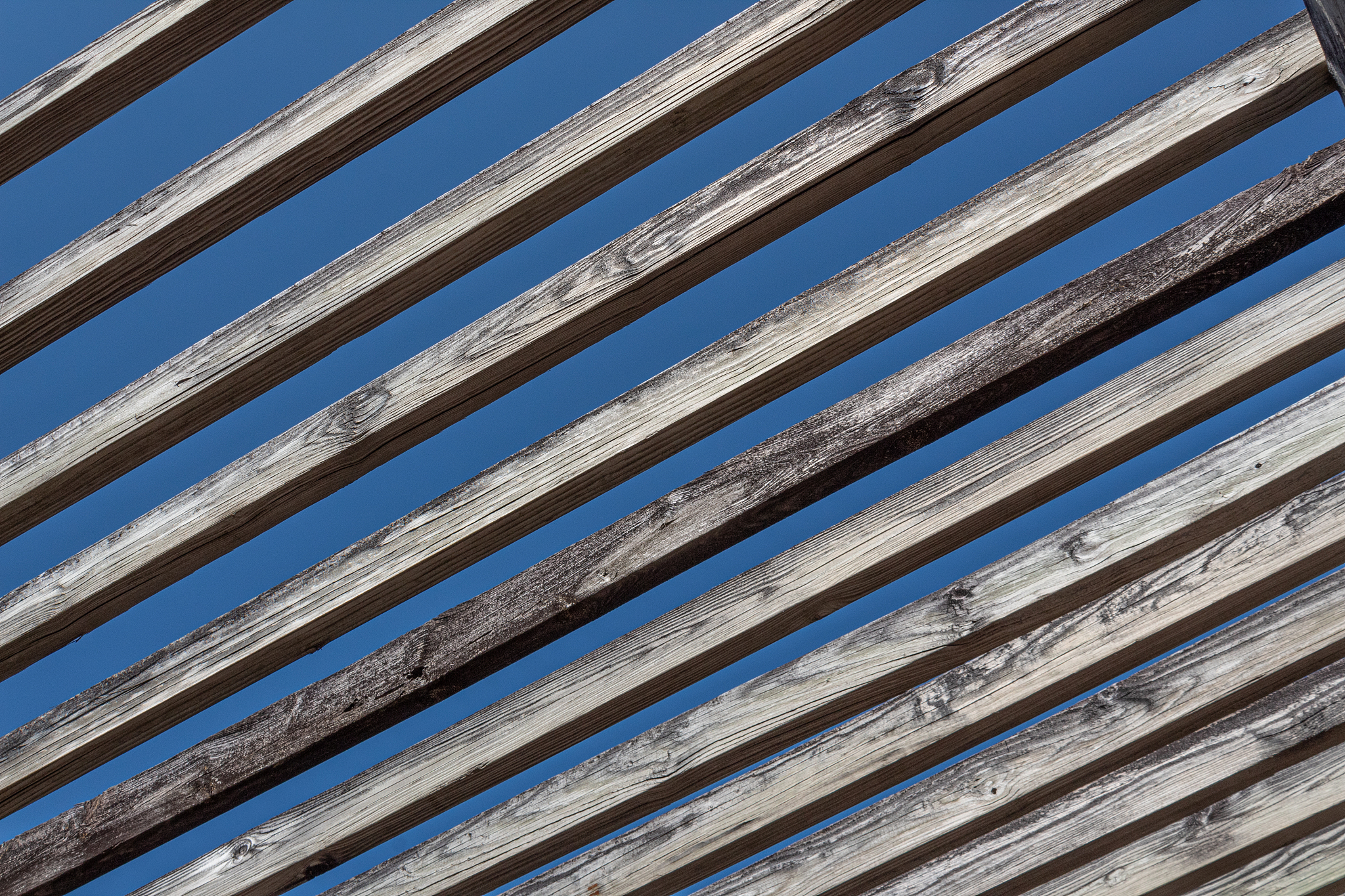 abstract background of old wooden beams against a blue sky, outd