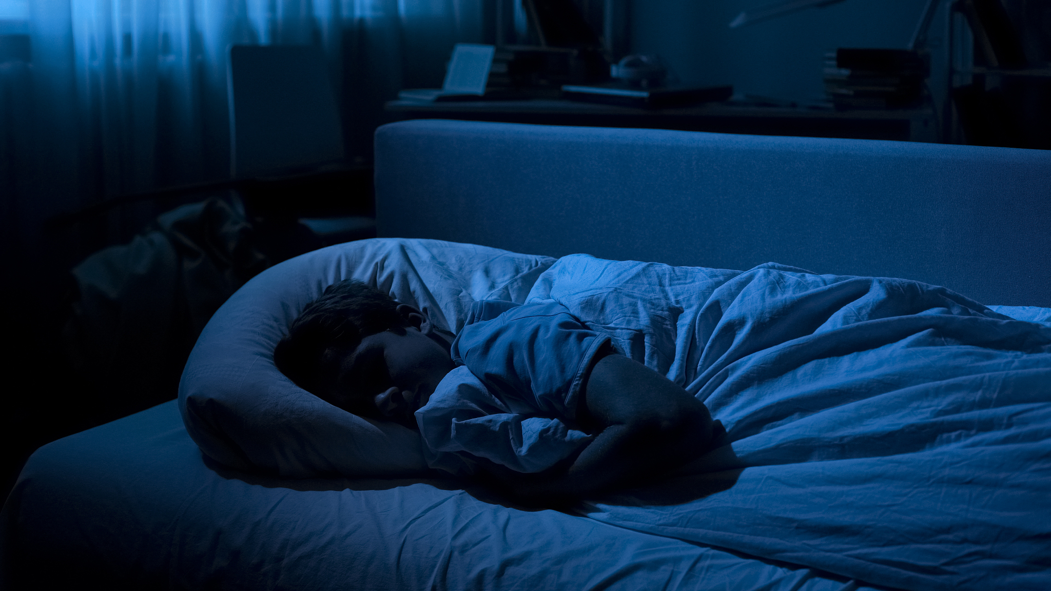 handsome teenager sleeping on comfortable sofa at night, healthy
