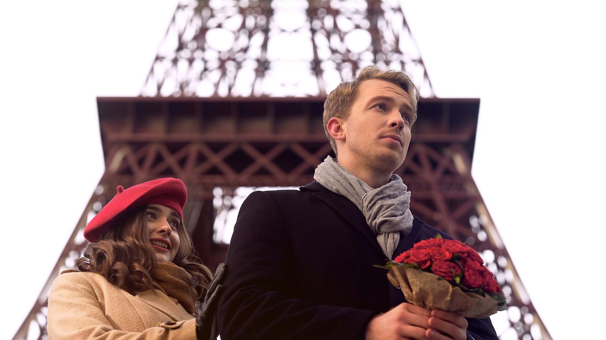 woman looking at beloved man with bouquet with embarrassment, la