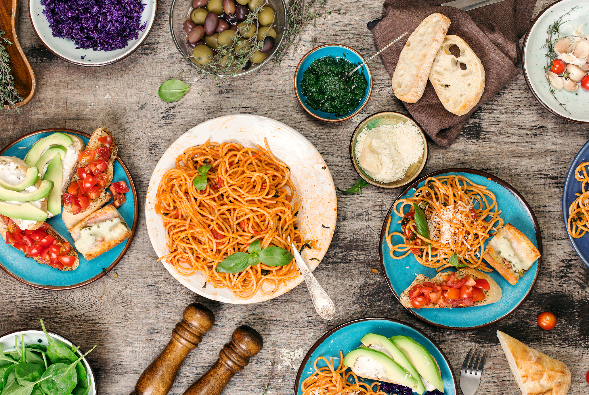 italian pasta with tomato sauce with snacks on wooden table