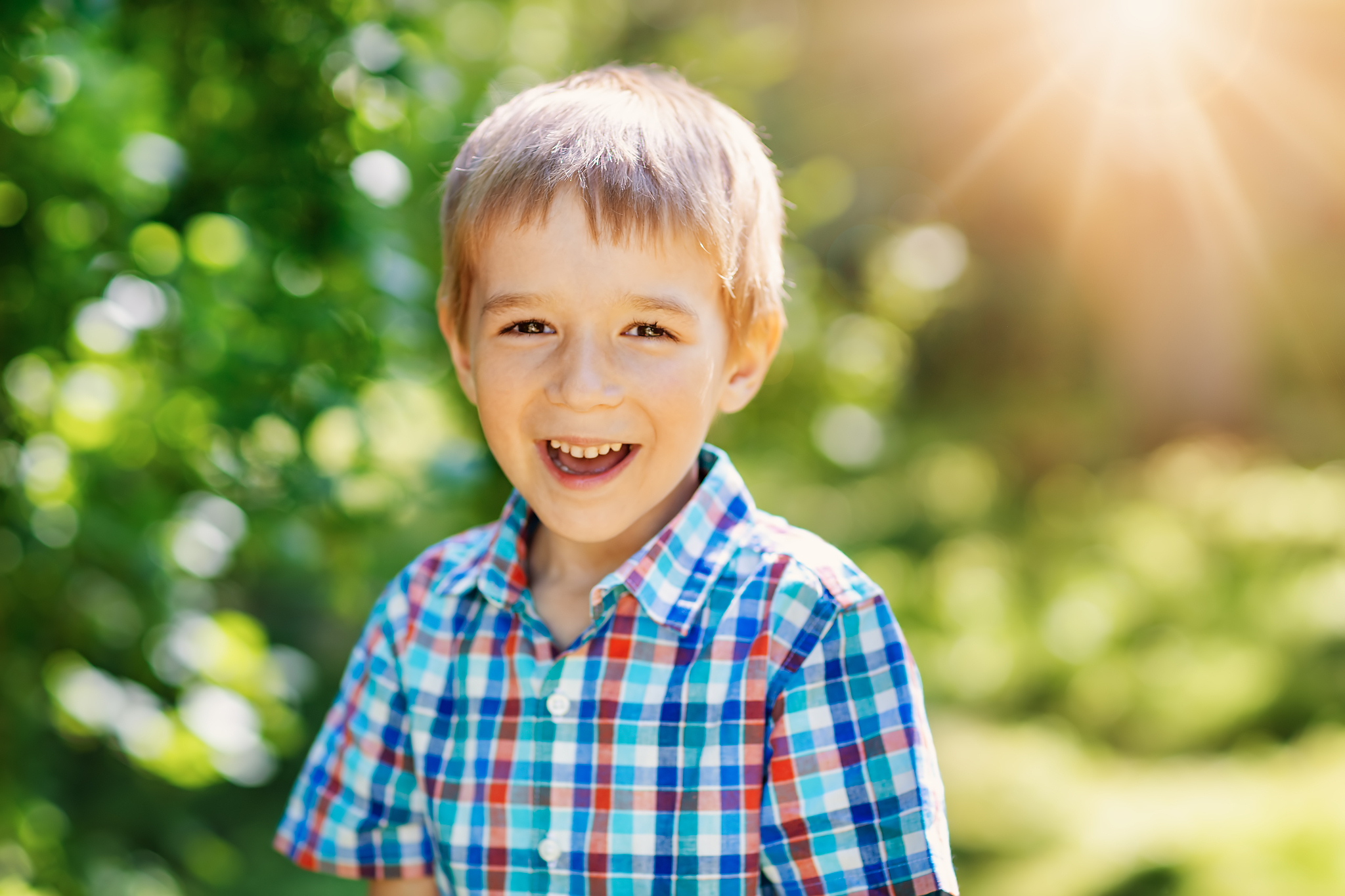 happy child smiling outdoors on sunny day