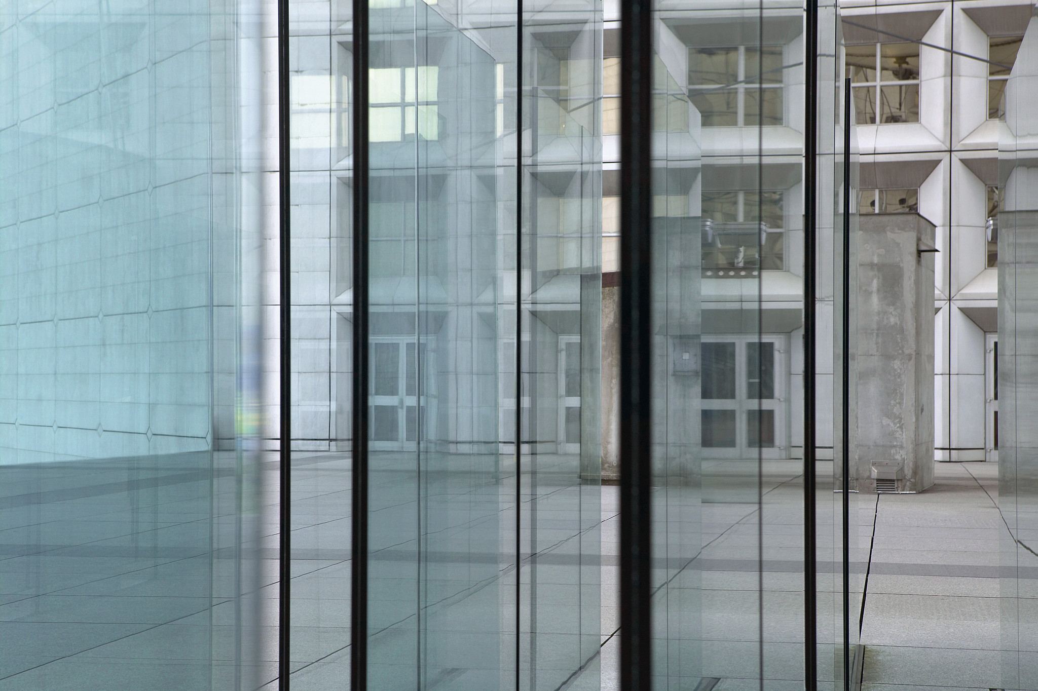 detail view of glass wall with a building in the background