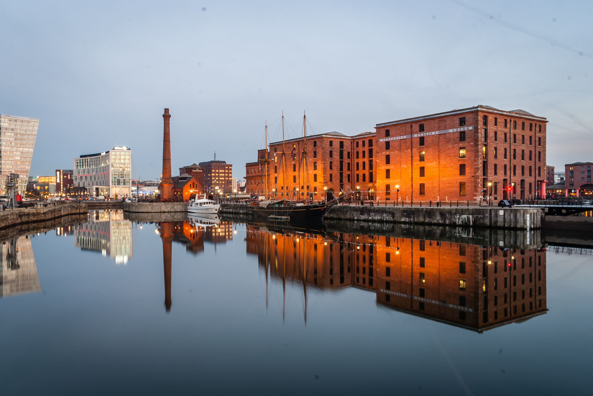 river with reflection against buildings in city