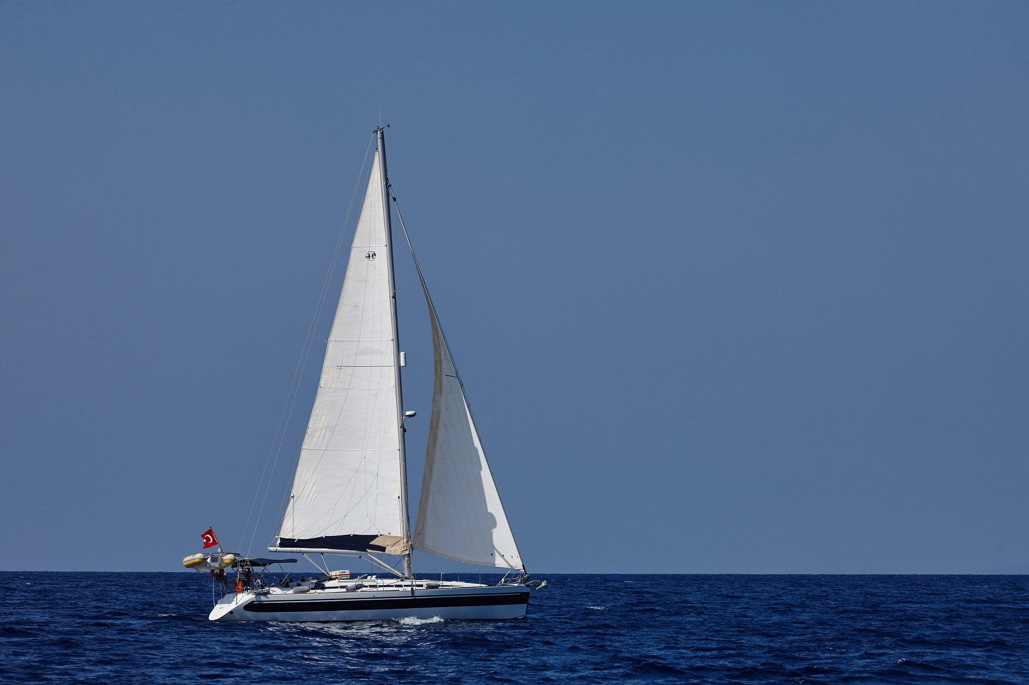 the white sails of yachts on the background of sea