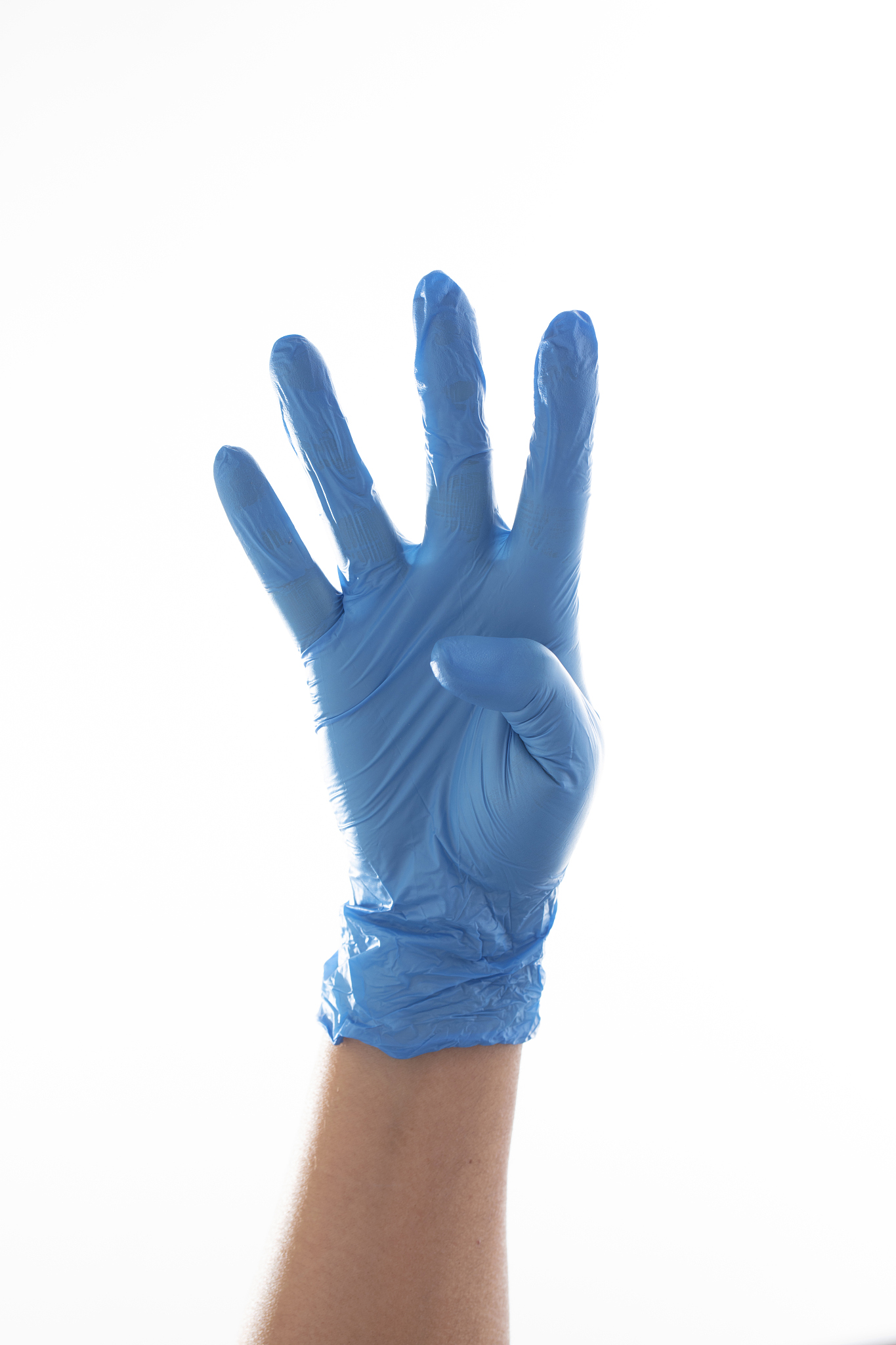 hand in blue glove showing number four with fingers.