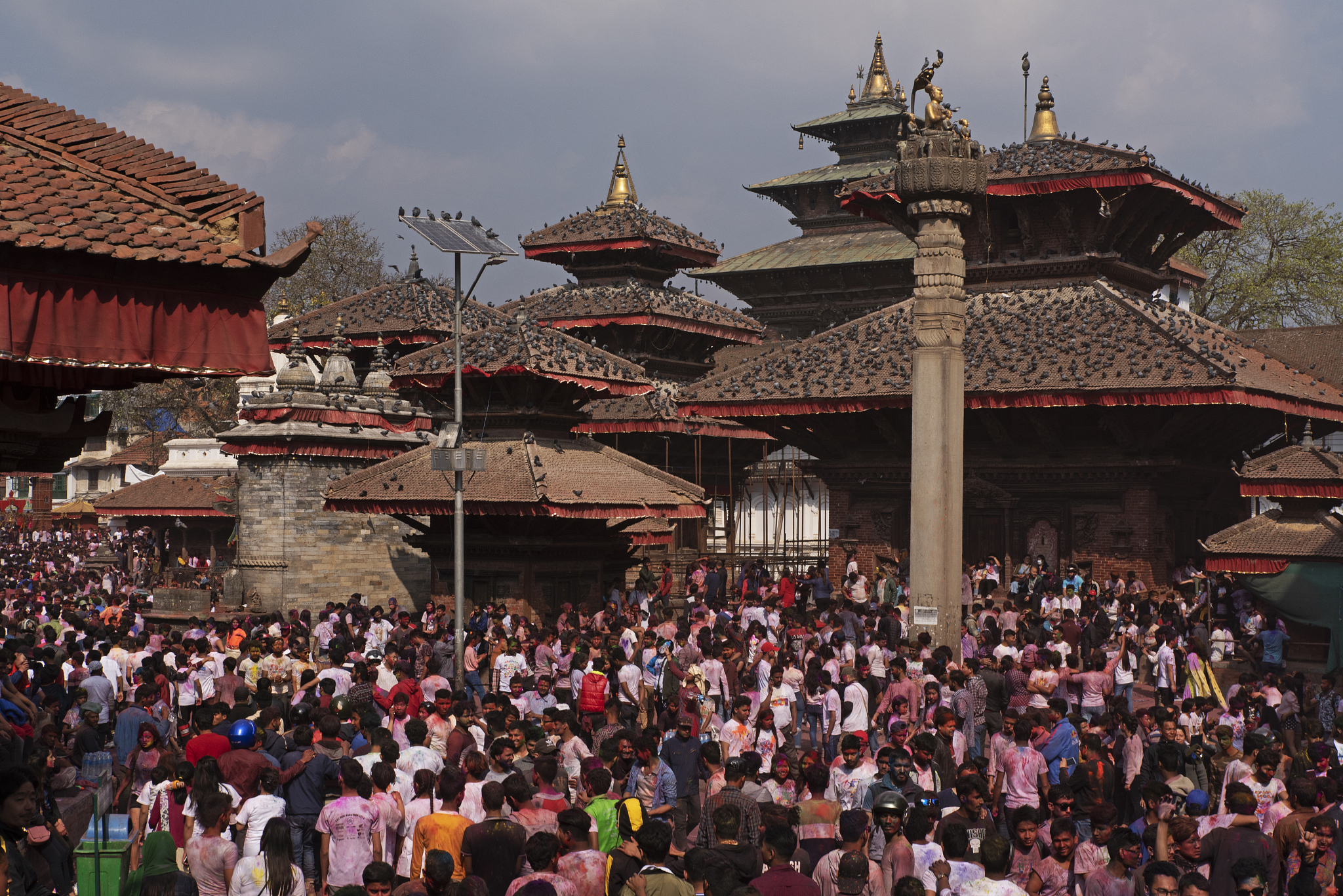 people celebrating holi festival at durbar square, kathmandu
