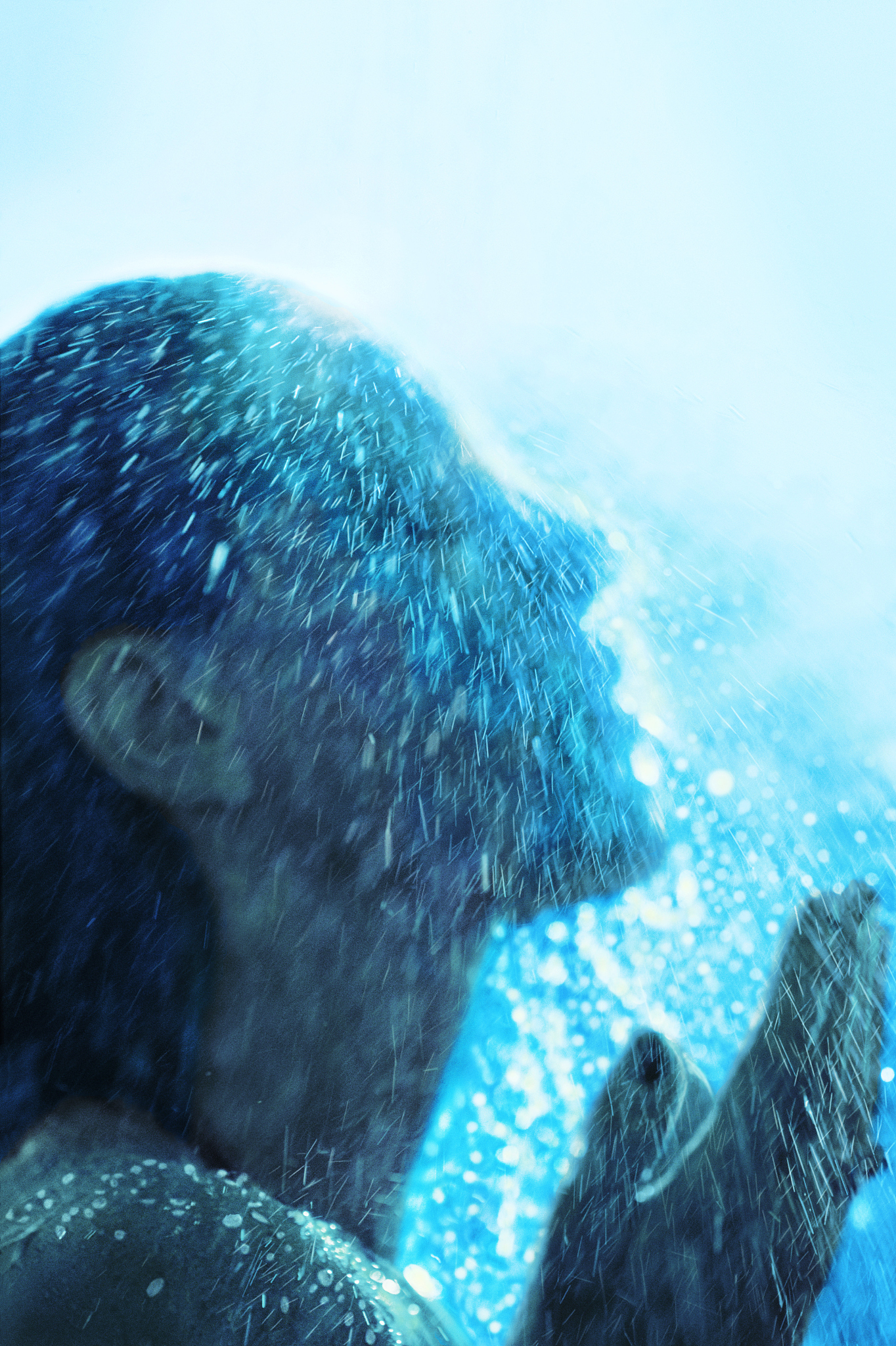 woman standing under outdoor shower, close-up