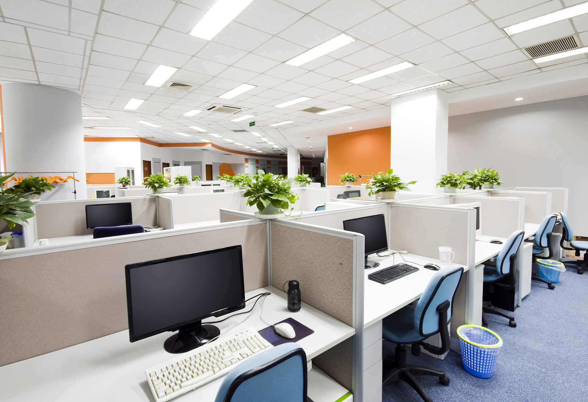 cubicles and desks with computers in modern office