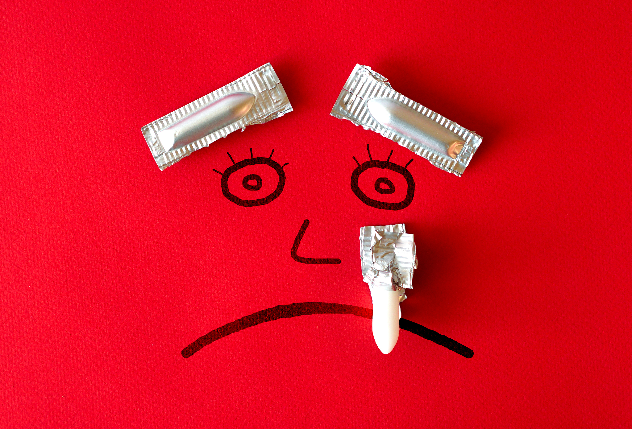hemorrhoid concept with painted sad face with eyebrows and a tea