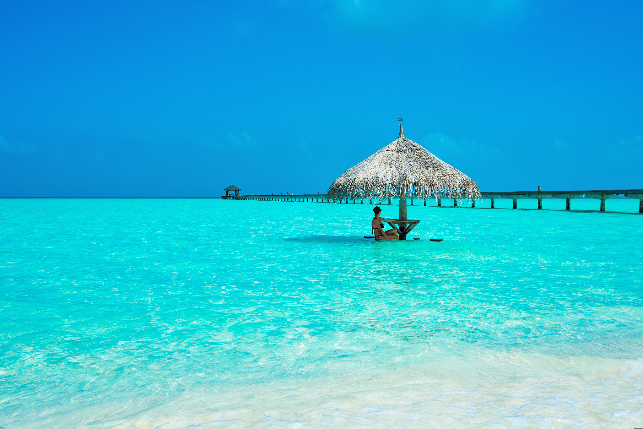young woman enjoying in sunshade at dhiffushi holiday island, so