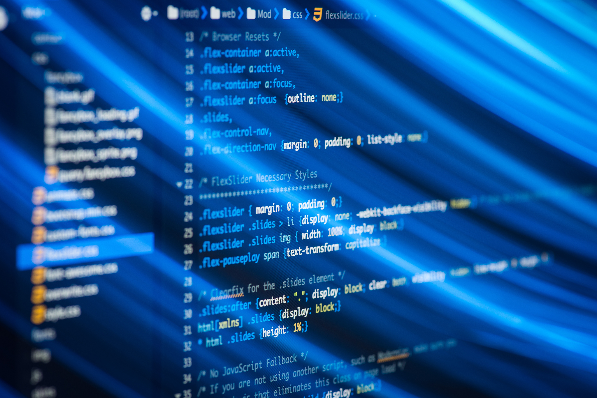 html and css code developing screenshot with light effects.