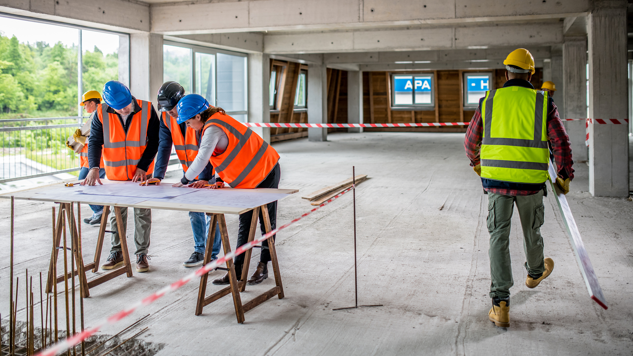 construction workers looking at blueprints