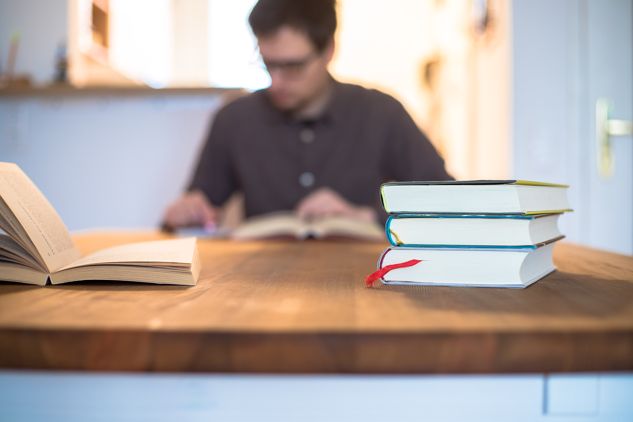 learning and studying concept. stack of books in foreground, you