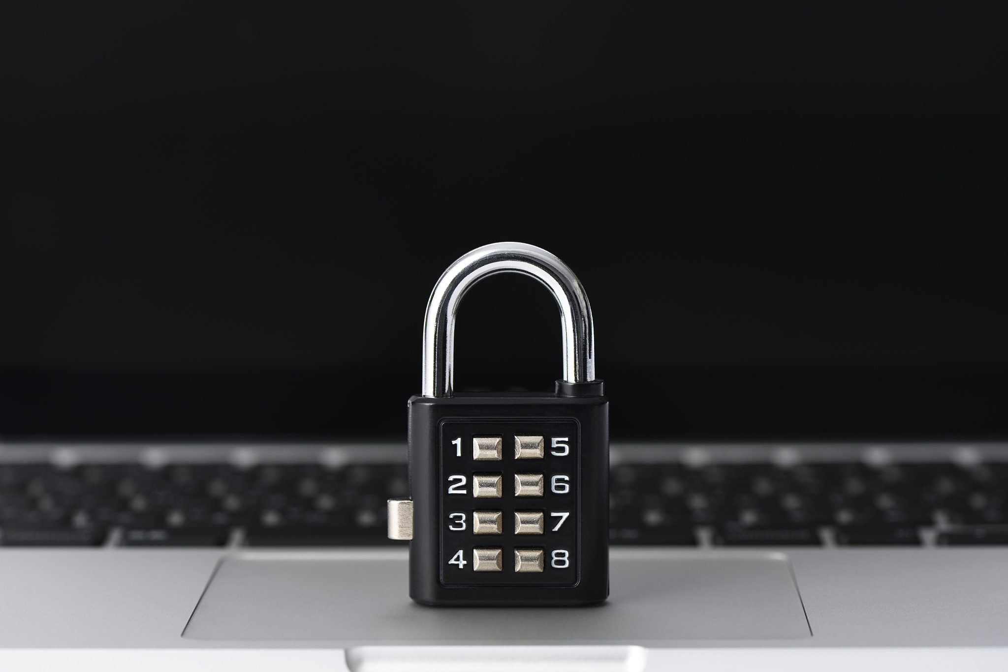 locked padlock on laptop with shallow depth of field
