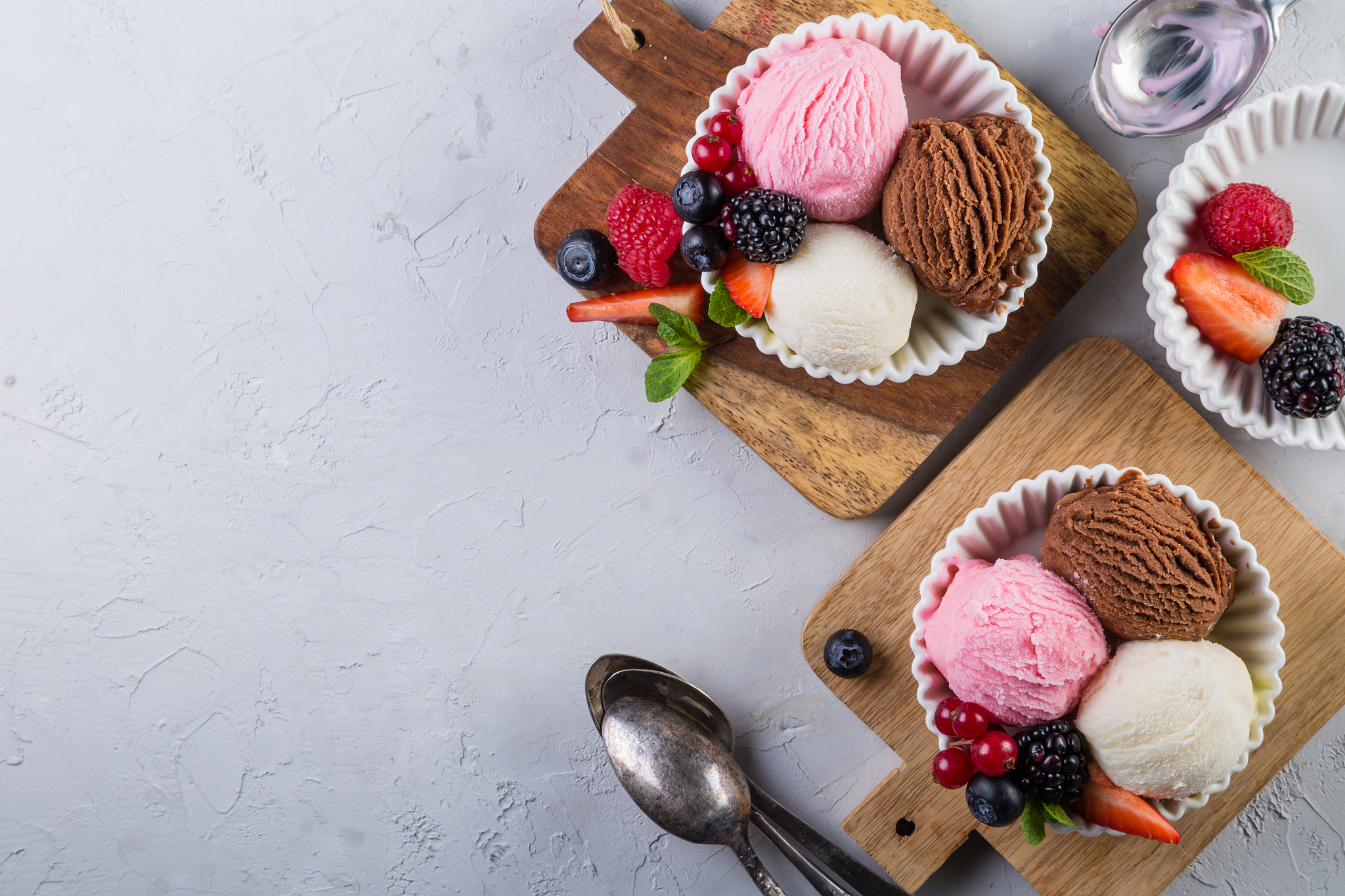 selection of colorful ice cream scoops in white bowls