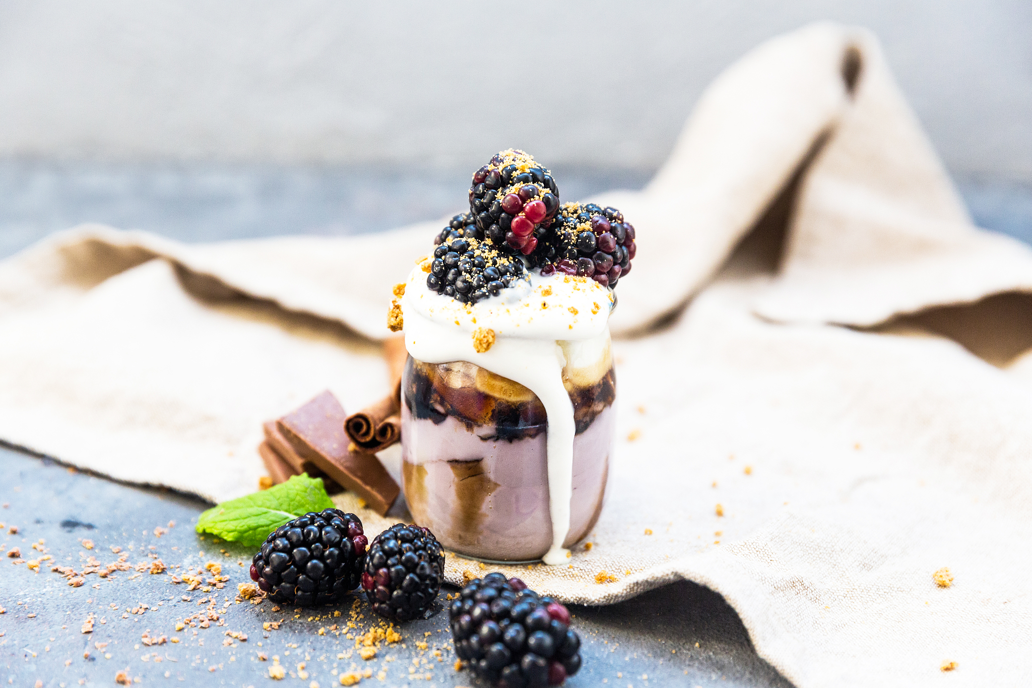 sweet dessert in glass with biscuit,berry fruit and whipped crea
