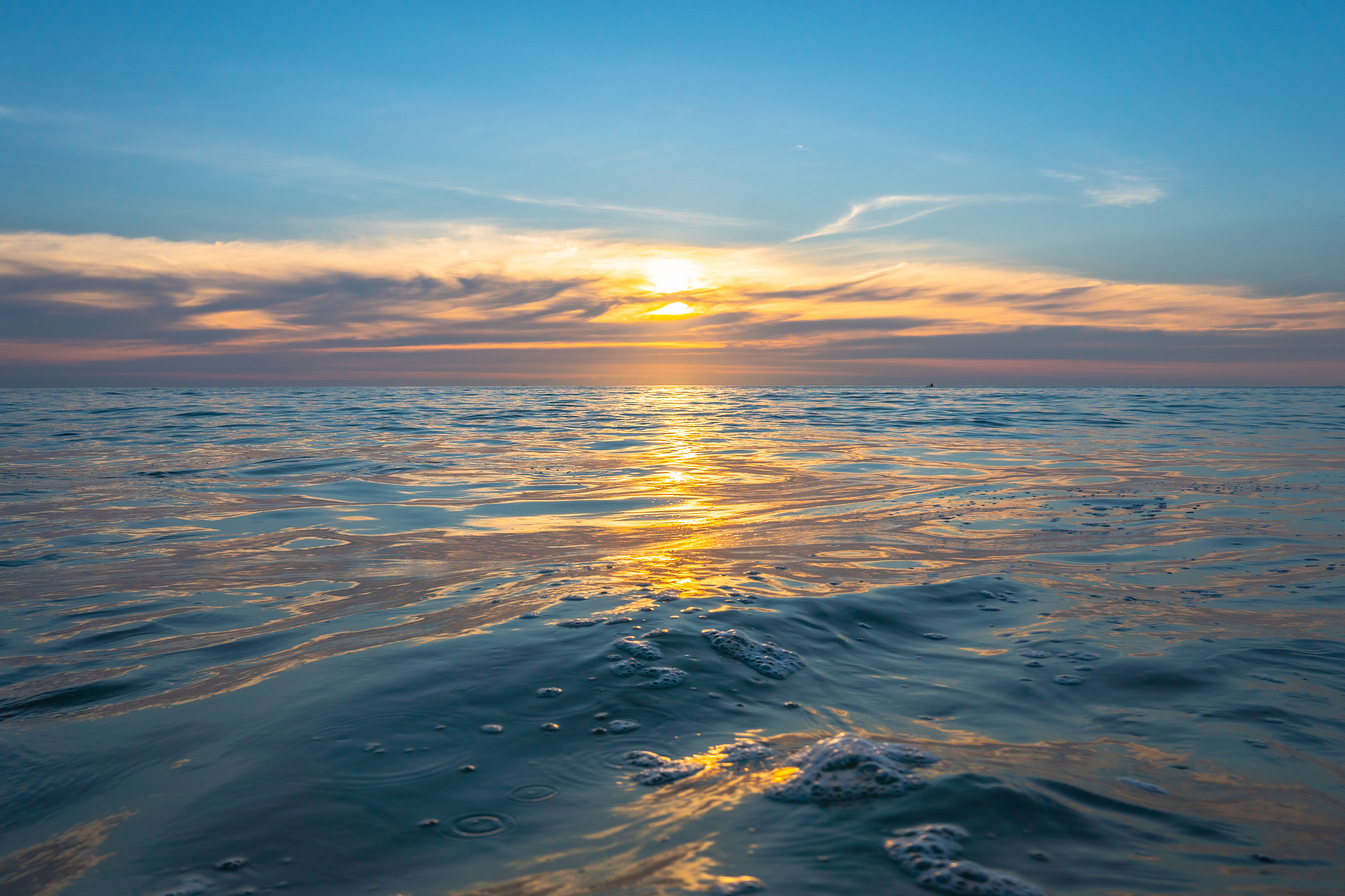 bubble of wave in te sea at sunset