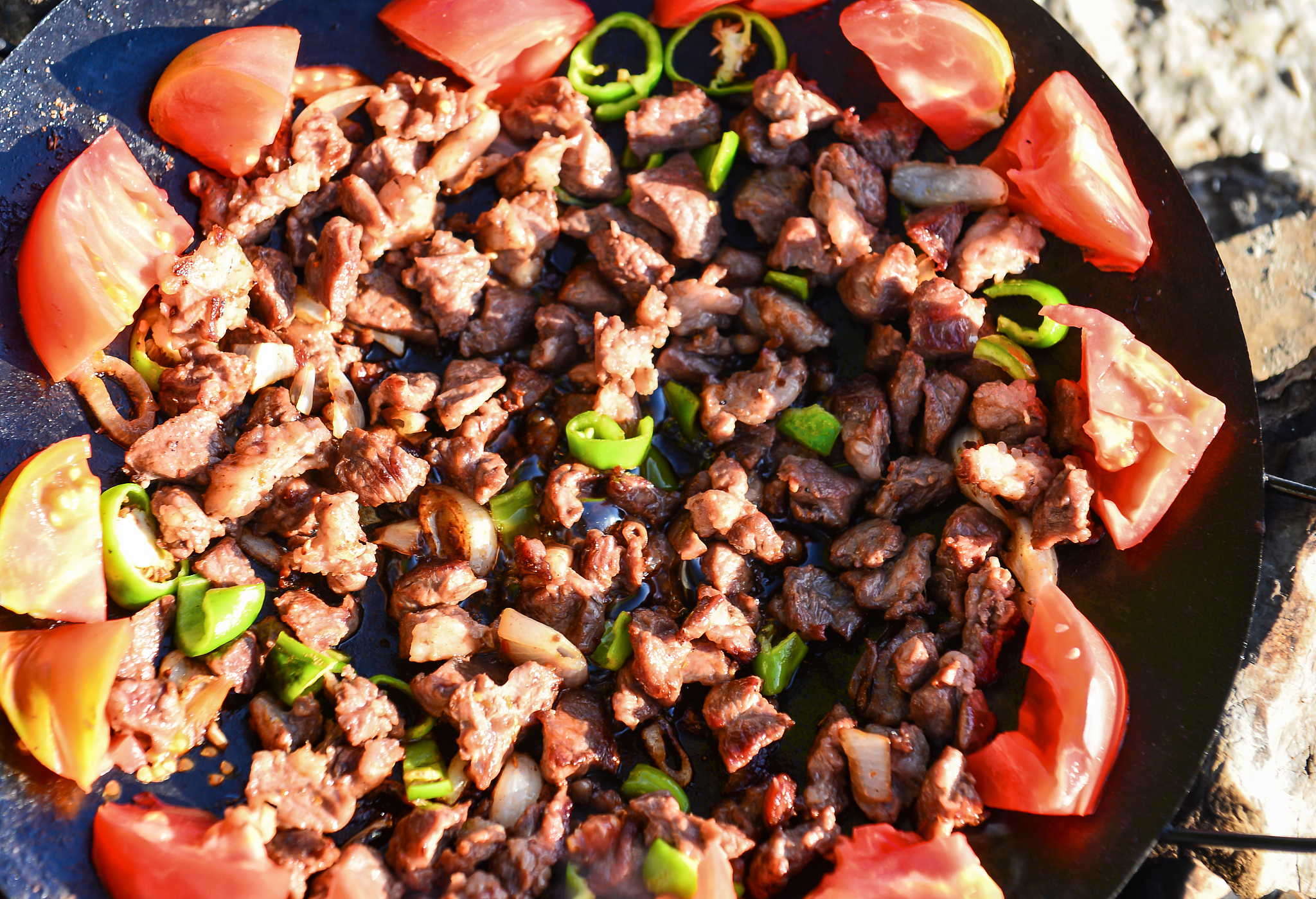 roasting meat in a wood fire