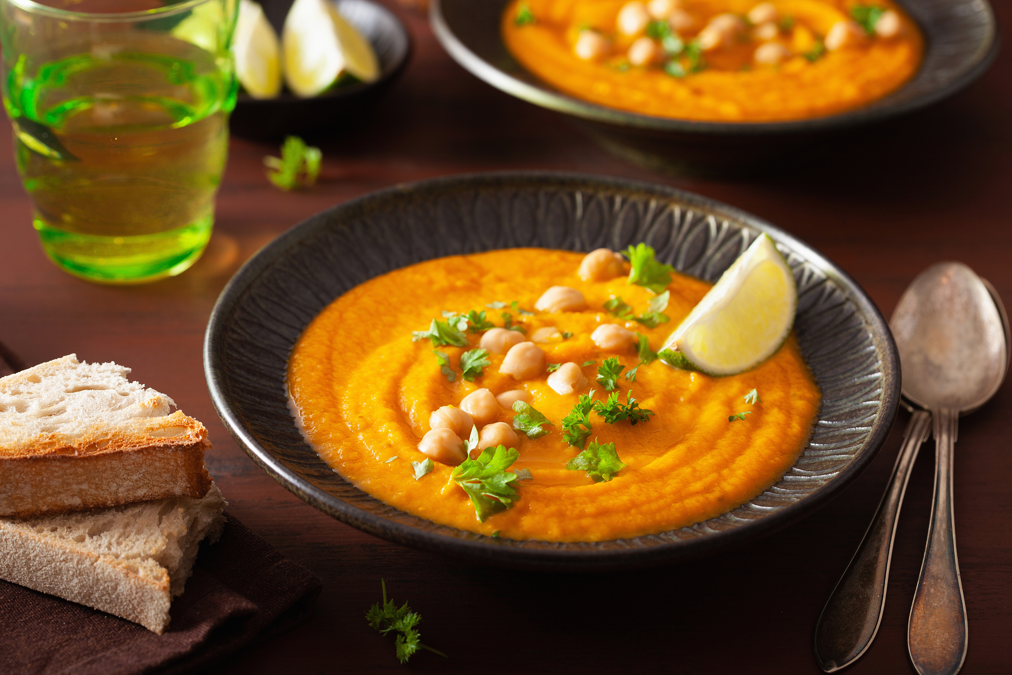 creamy carrot chickpea soup on dark rustic background