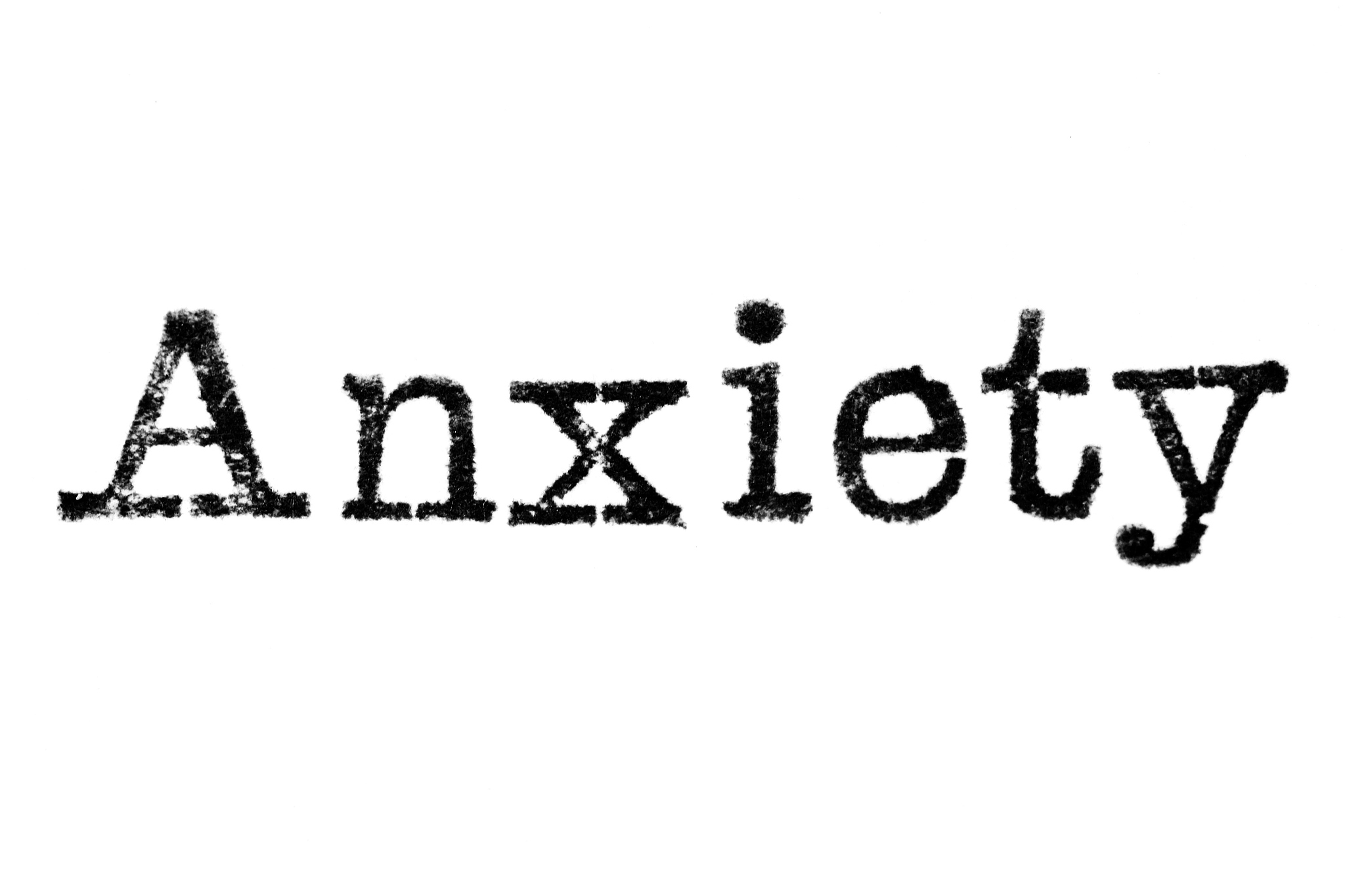the word 'anxiety' from a typewriter on white
