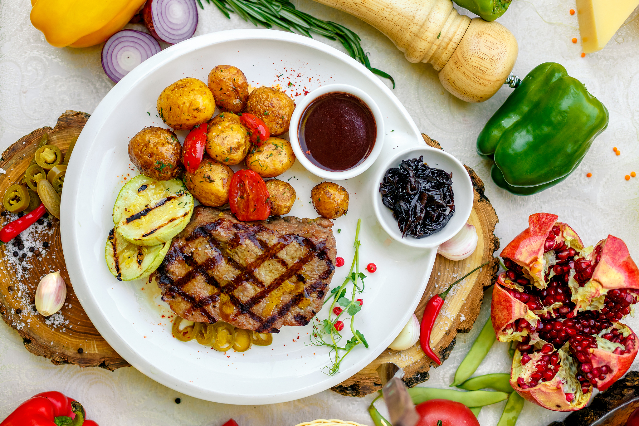 bbq, juicy steak with grilled vegetables and sauce on a white pl