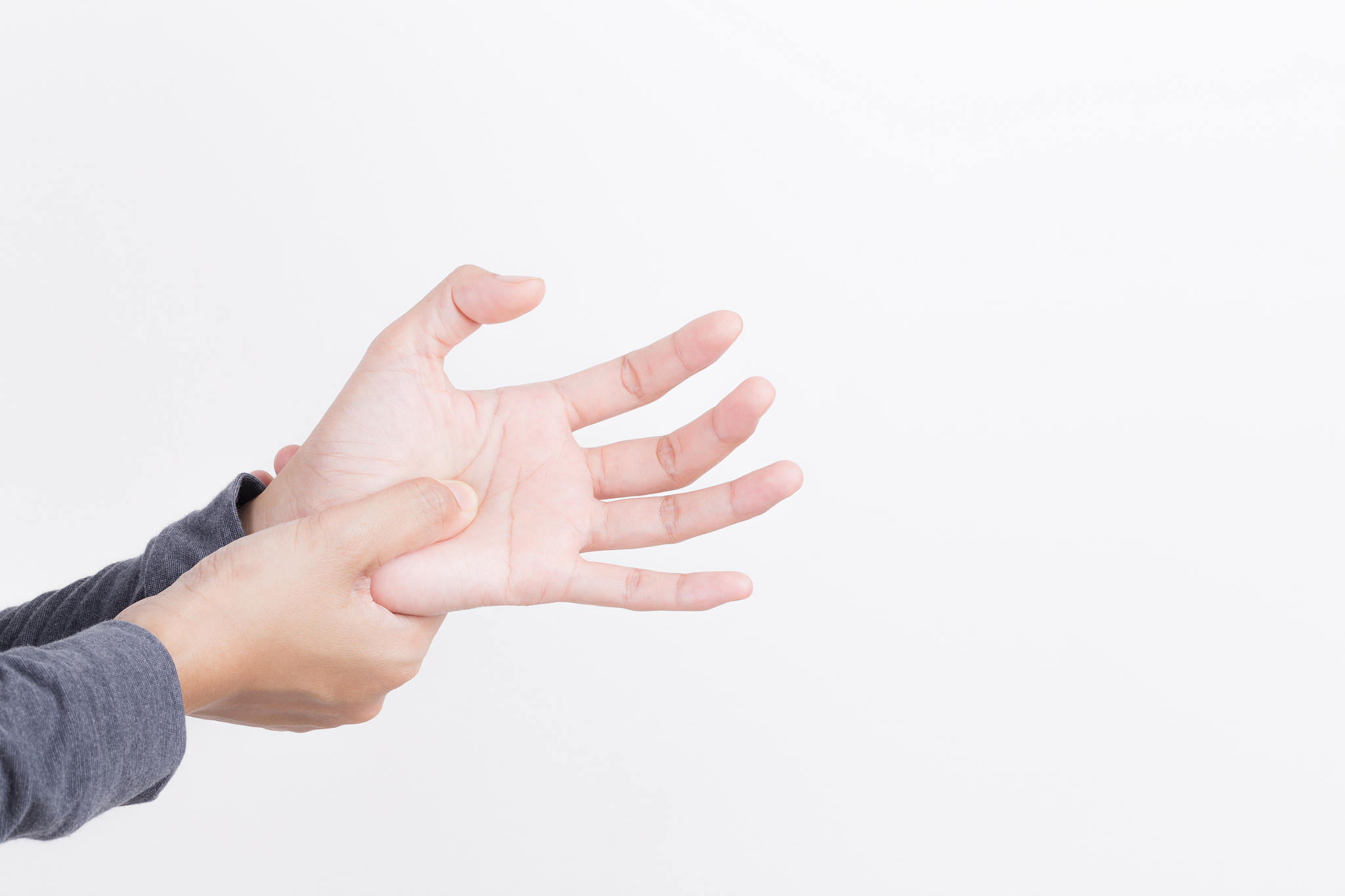 cropped hand pressing palm against white background