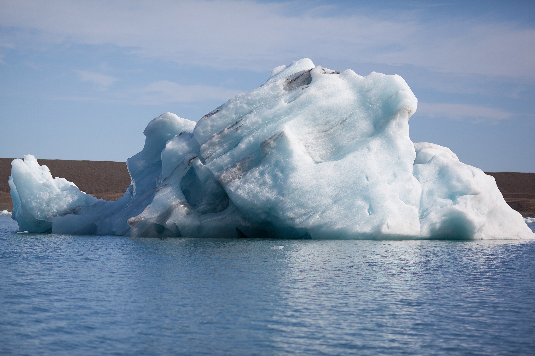 icebergs floating on sea against sky