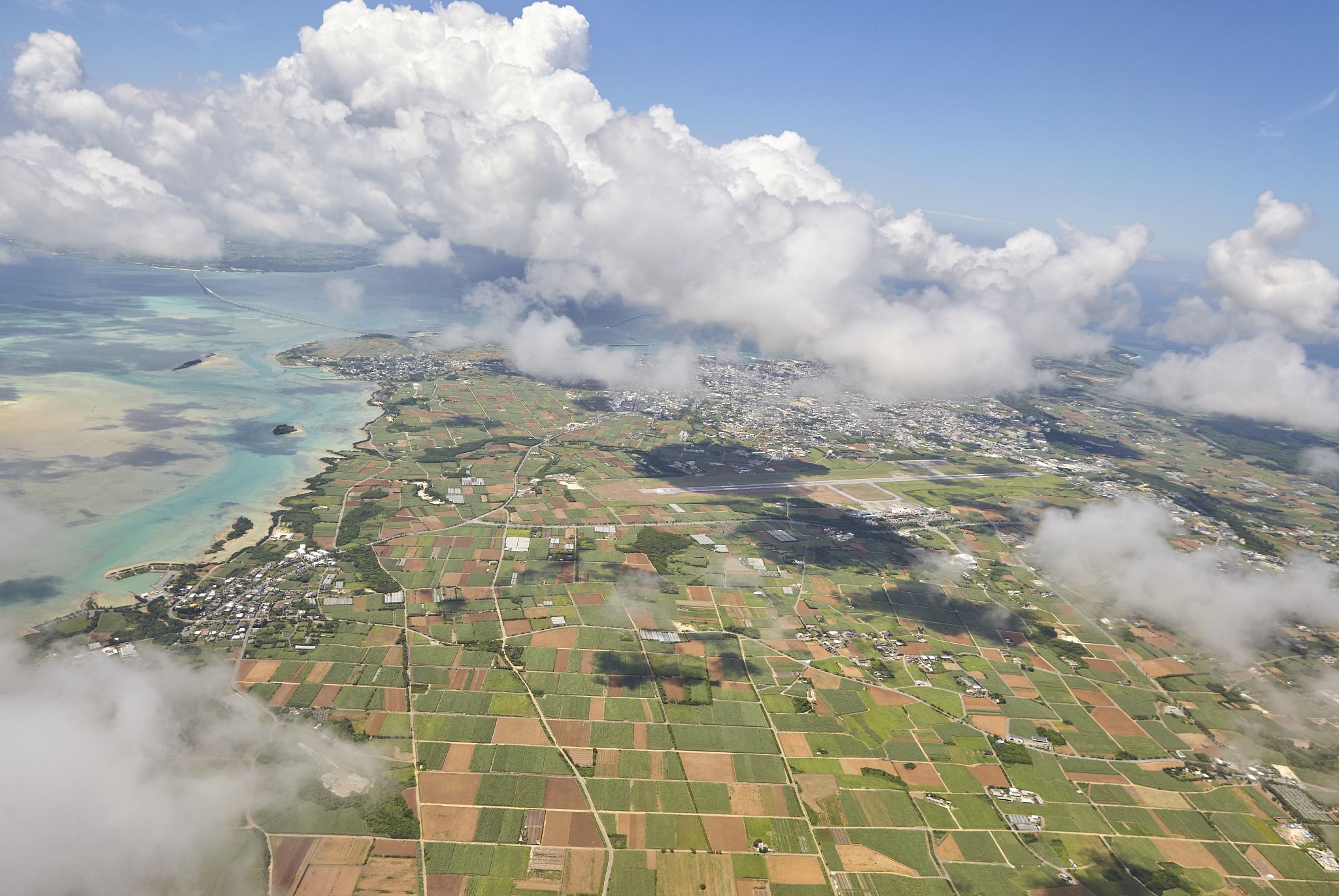 airplane flying over miyako island, okinawa japan