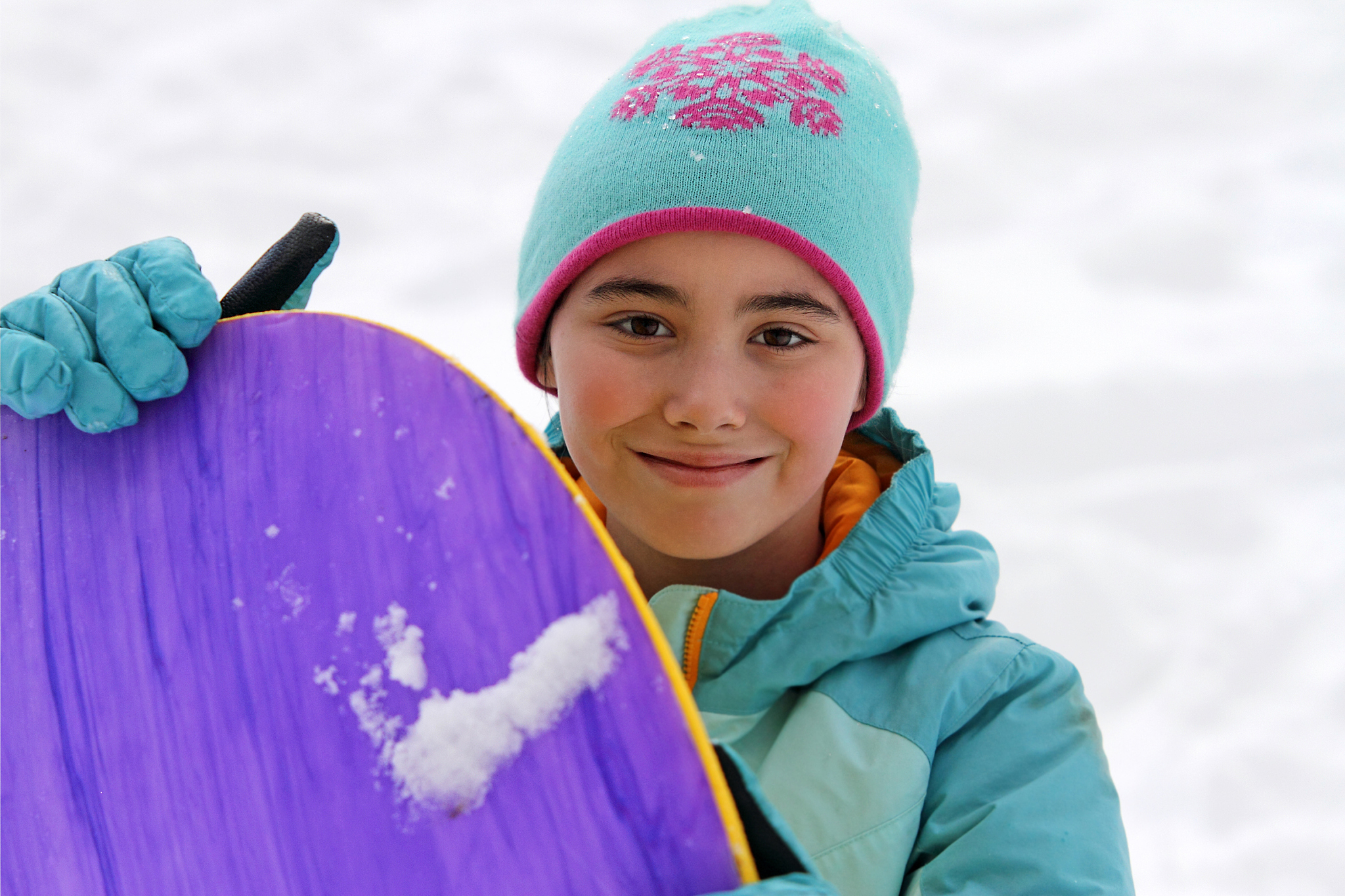 winter child holding sled