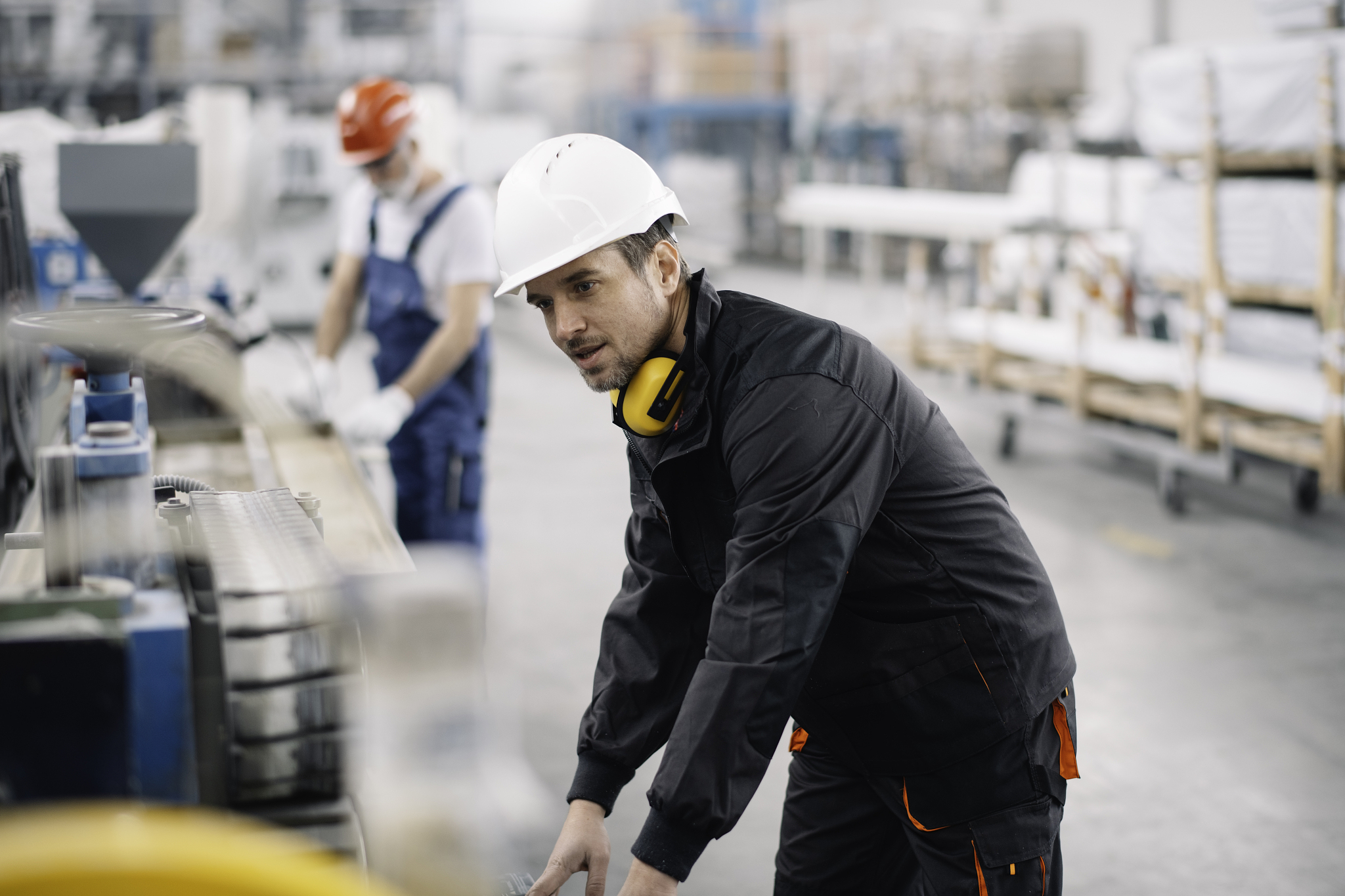 portrait of worker in factory. young handsome man working in fac