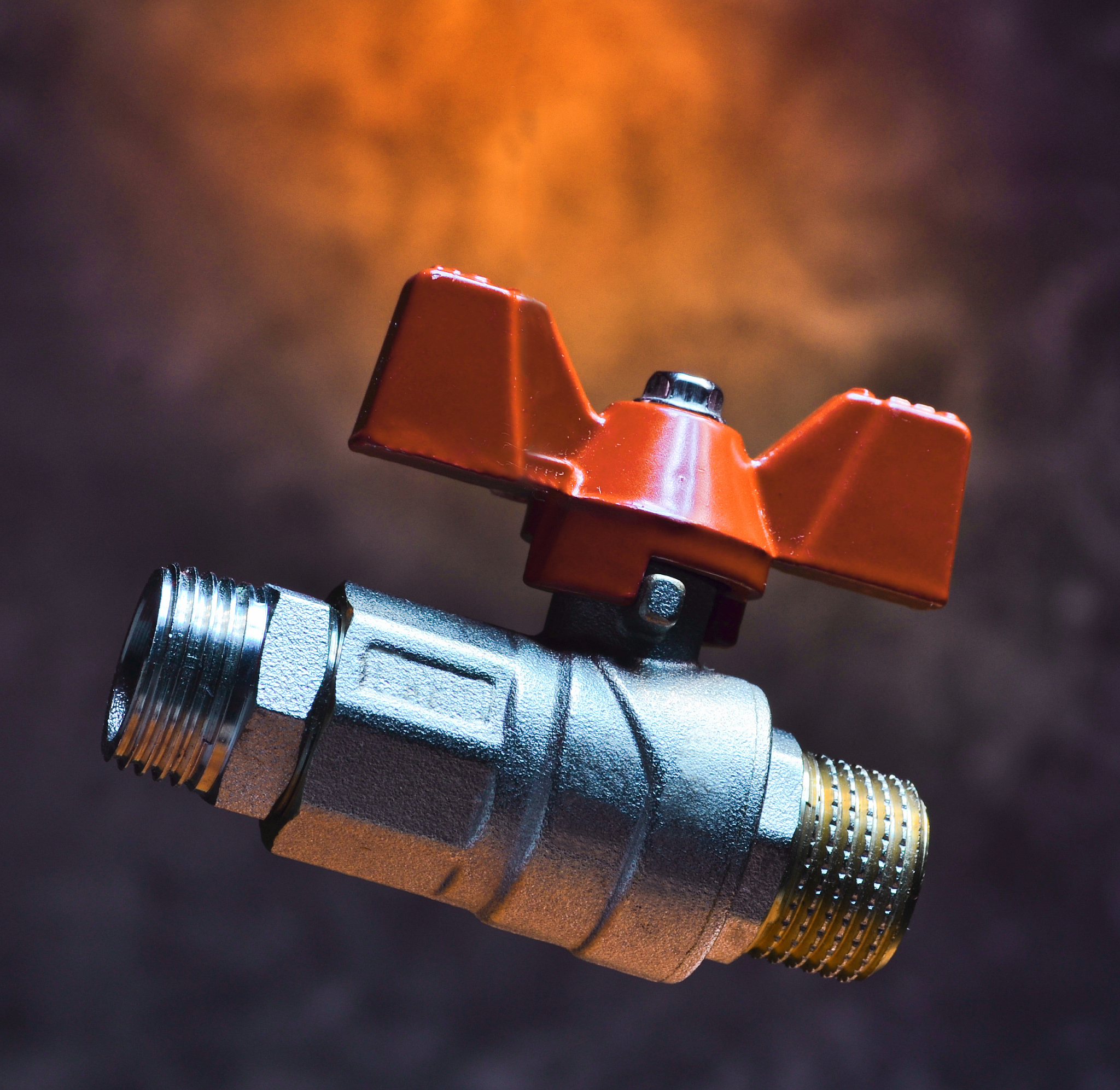 ball valve on the background of a concrete wall. mystical red li