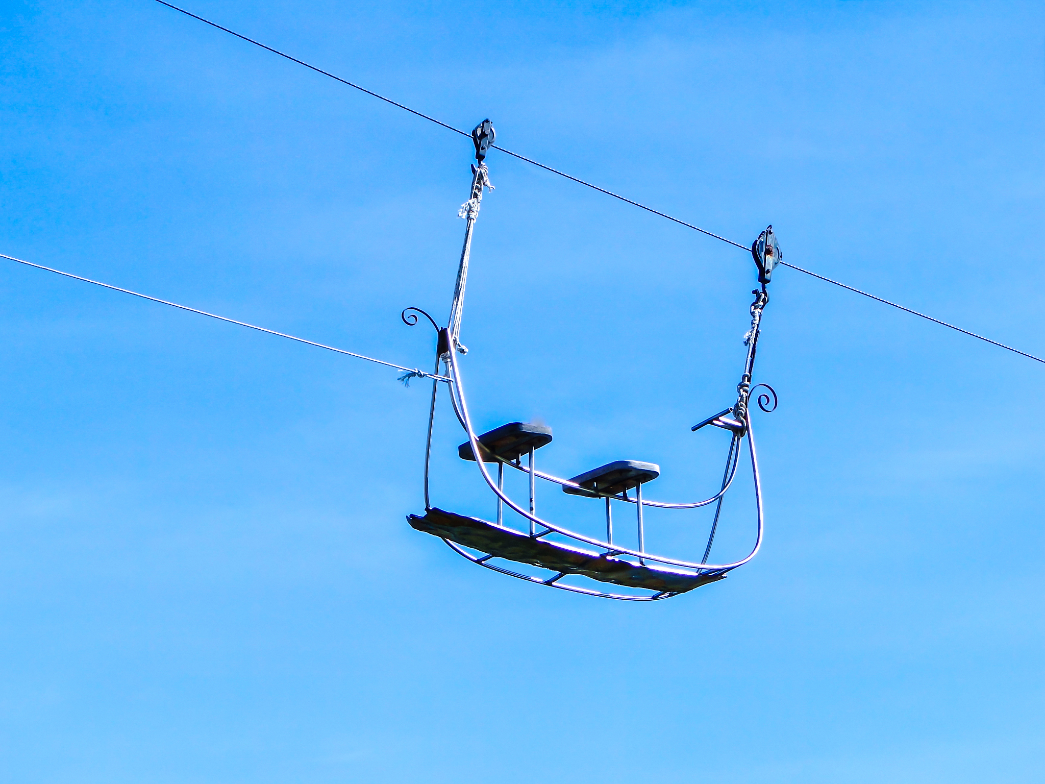 a silhouette of air-cable car isolated on blue background.