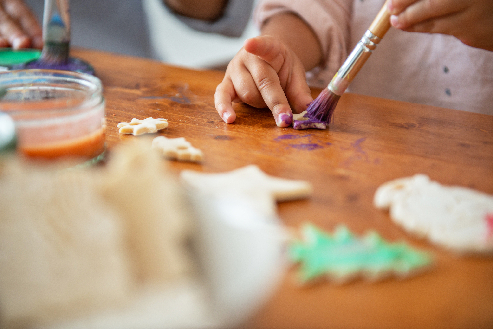 mother and daughter painting christmass ornaments