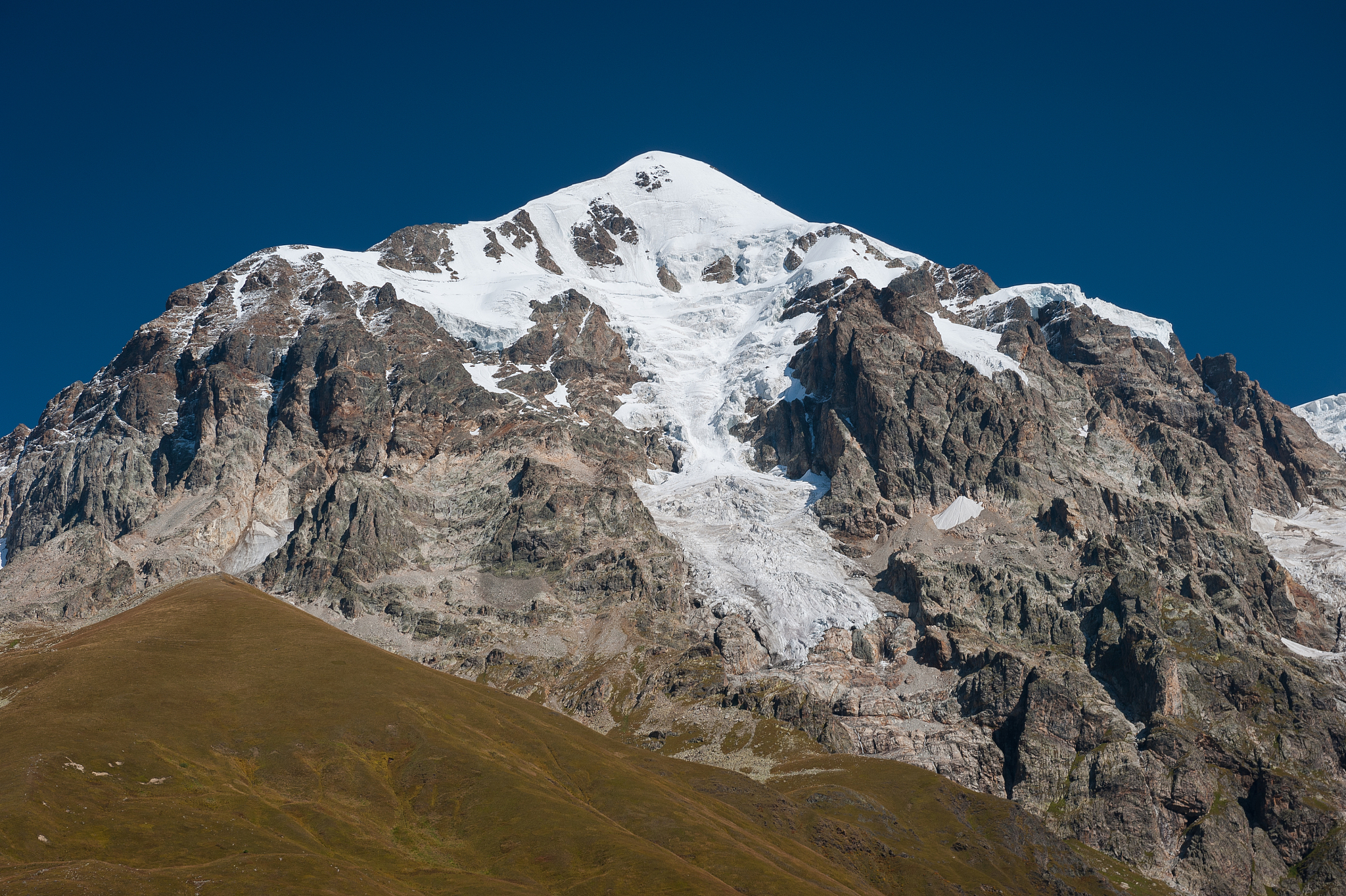 tetnuldi peak (4860m) in the caucasus mountains seen from chkhun