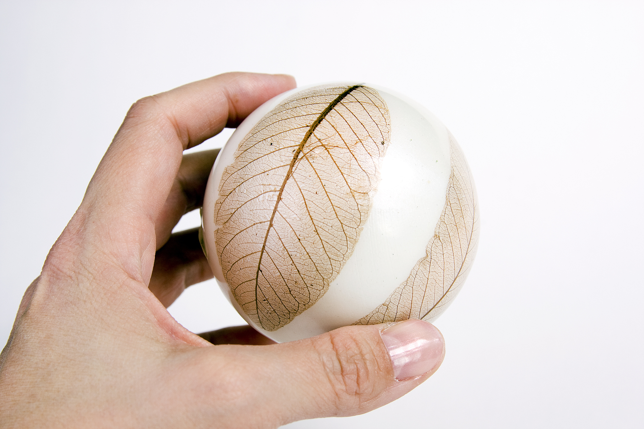 hand holding white leaf ball