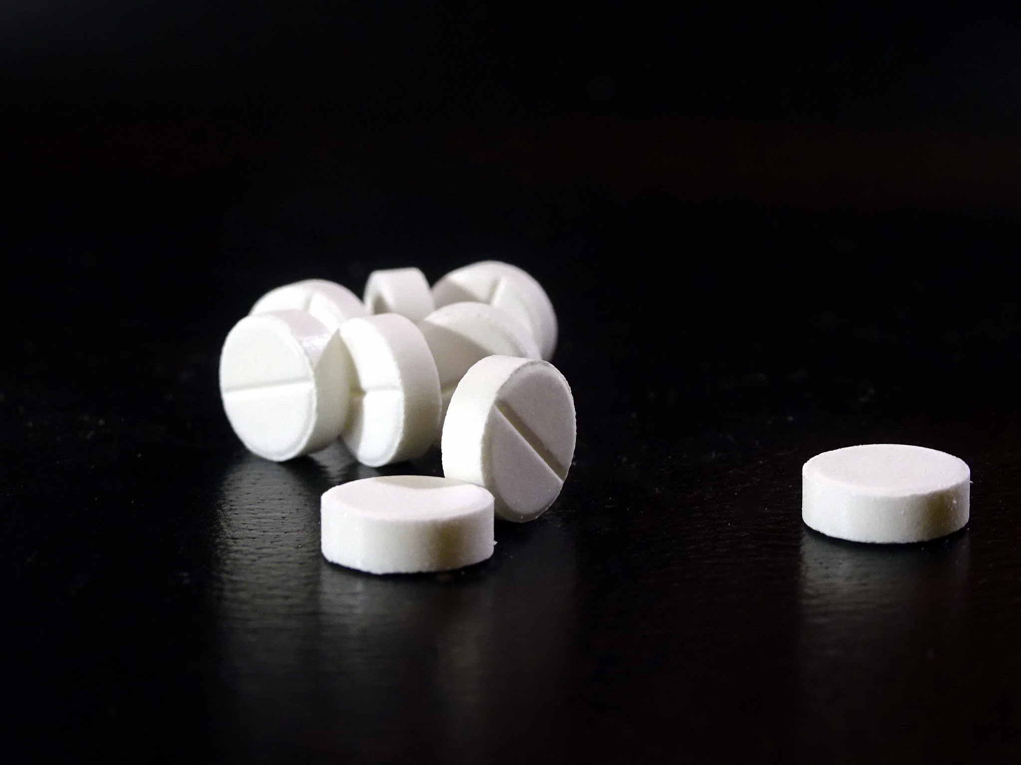 white pills close-up on dark