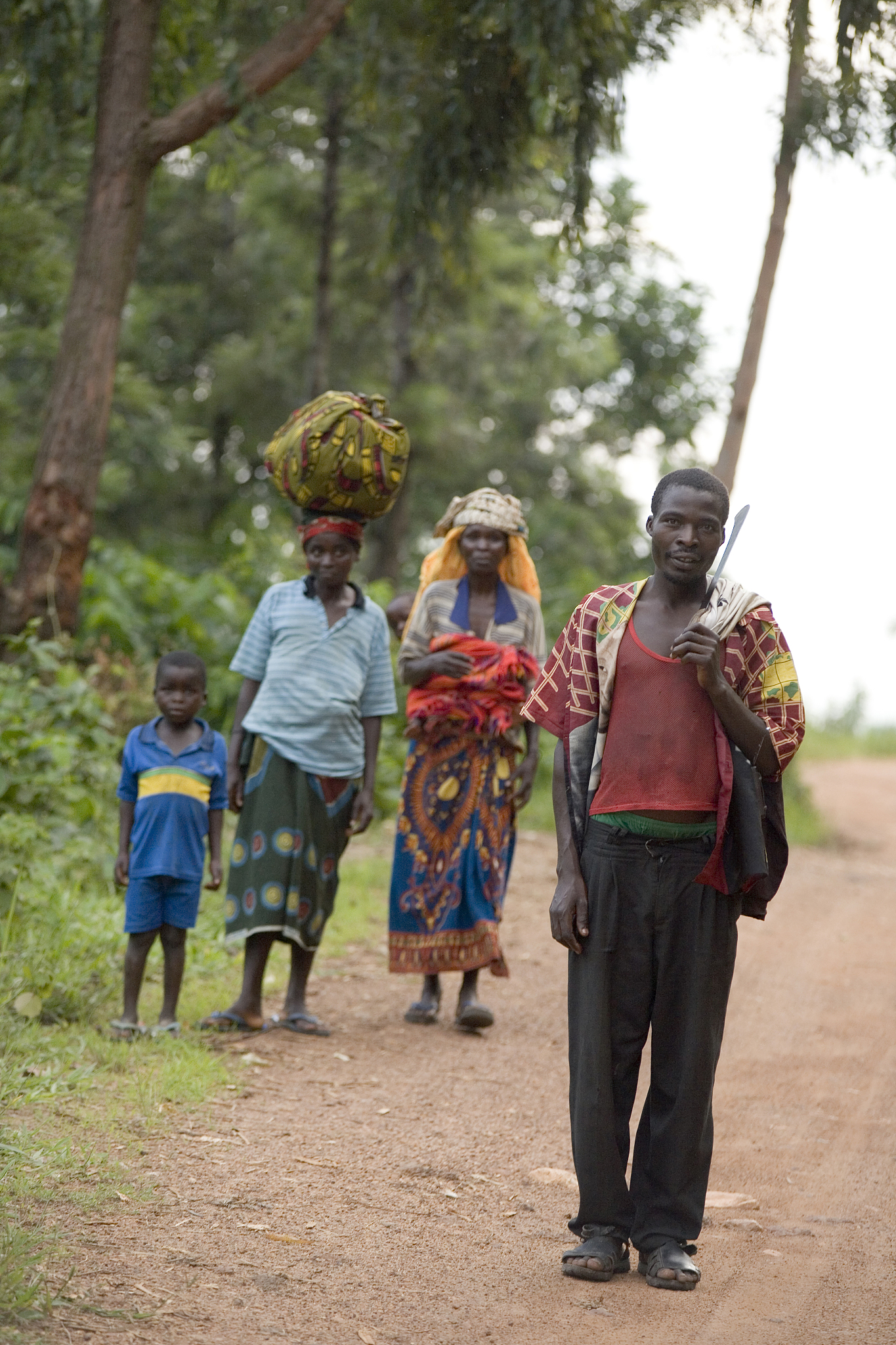 portrait of man, women and boy on dirt track, masango, cibitoke,