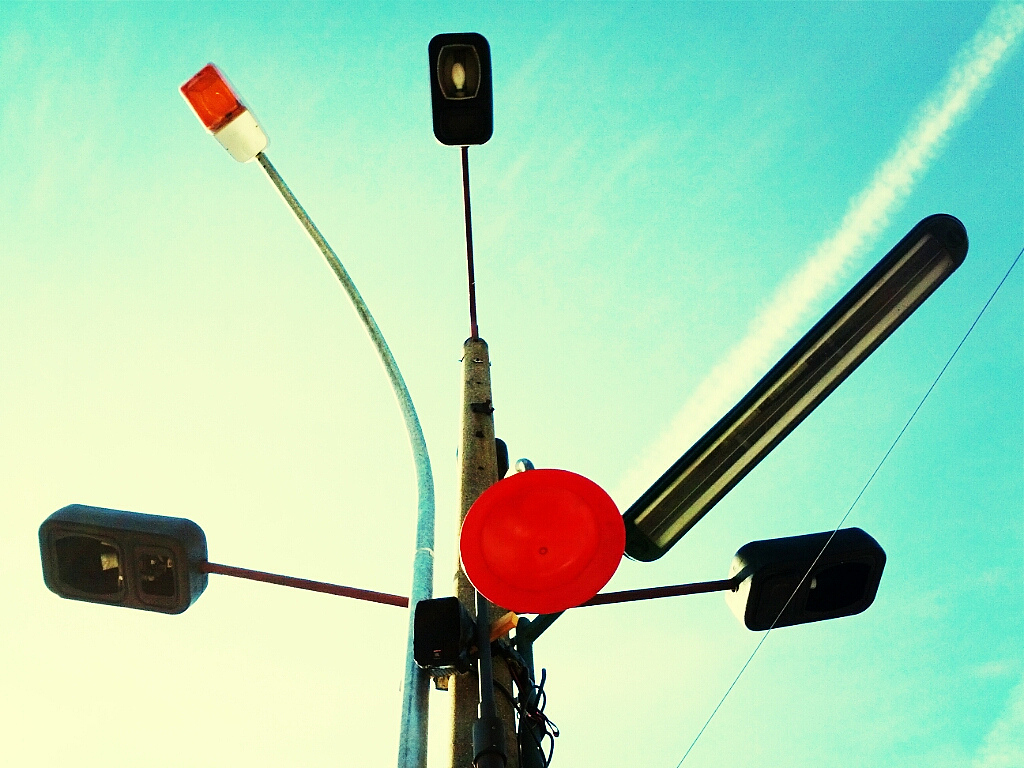 low angle view of various lights against blue sky