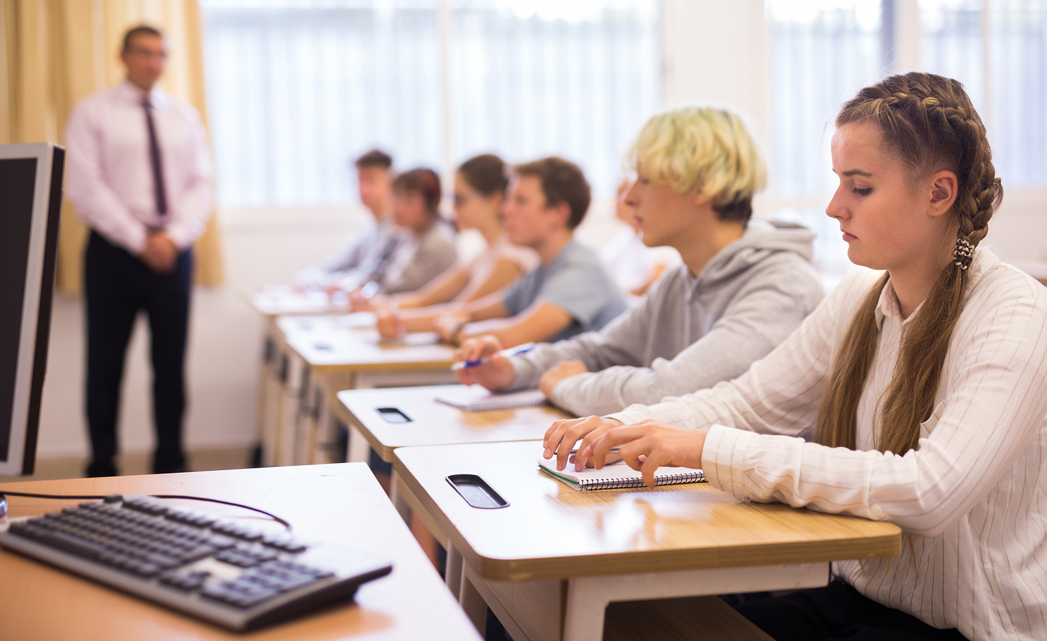 teenage students working at class during lesson