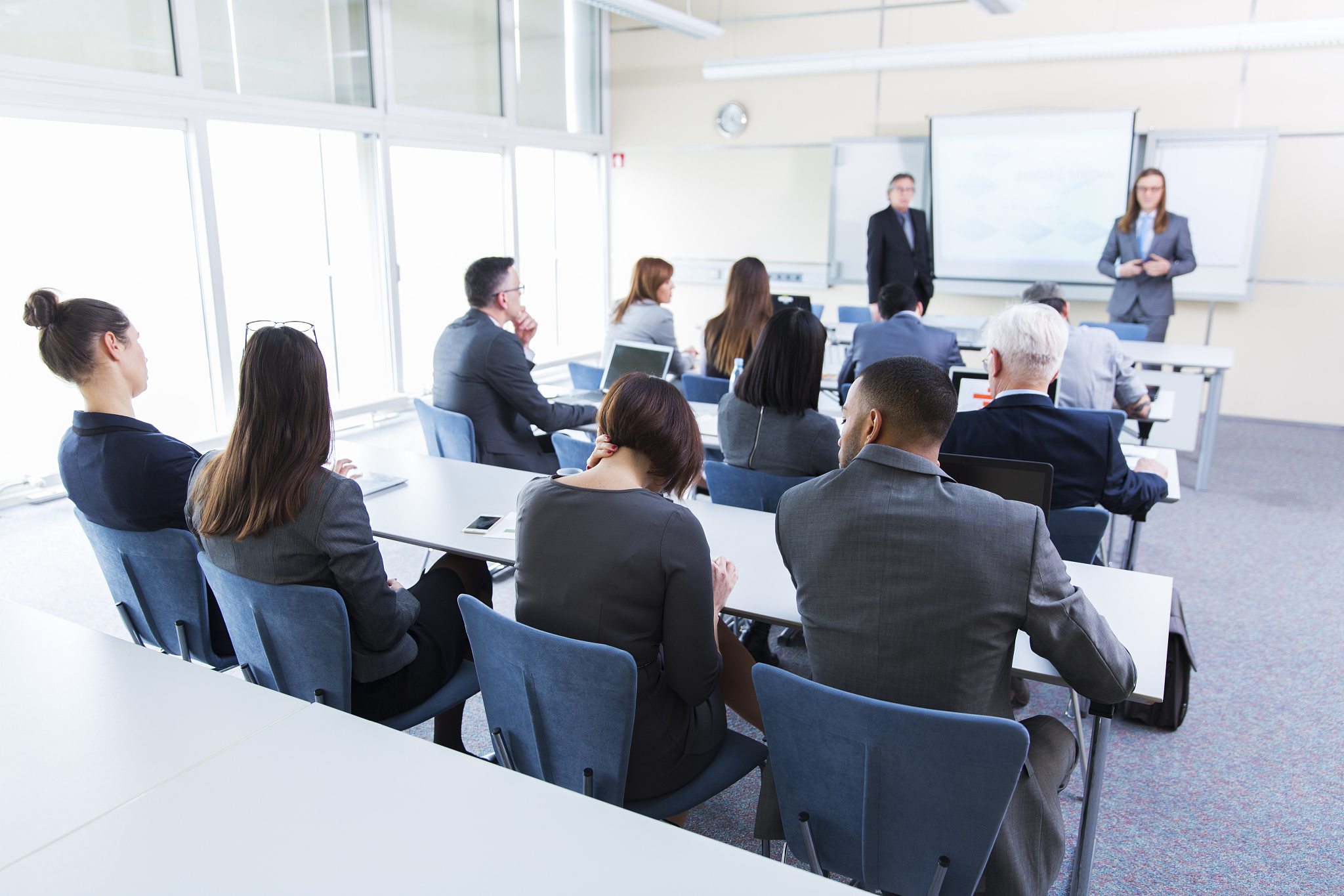 business people in a classroom listening lecturer