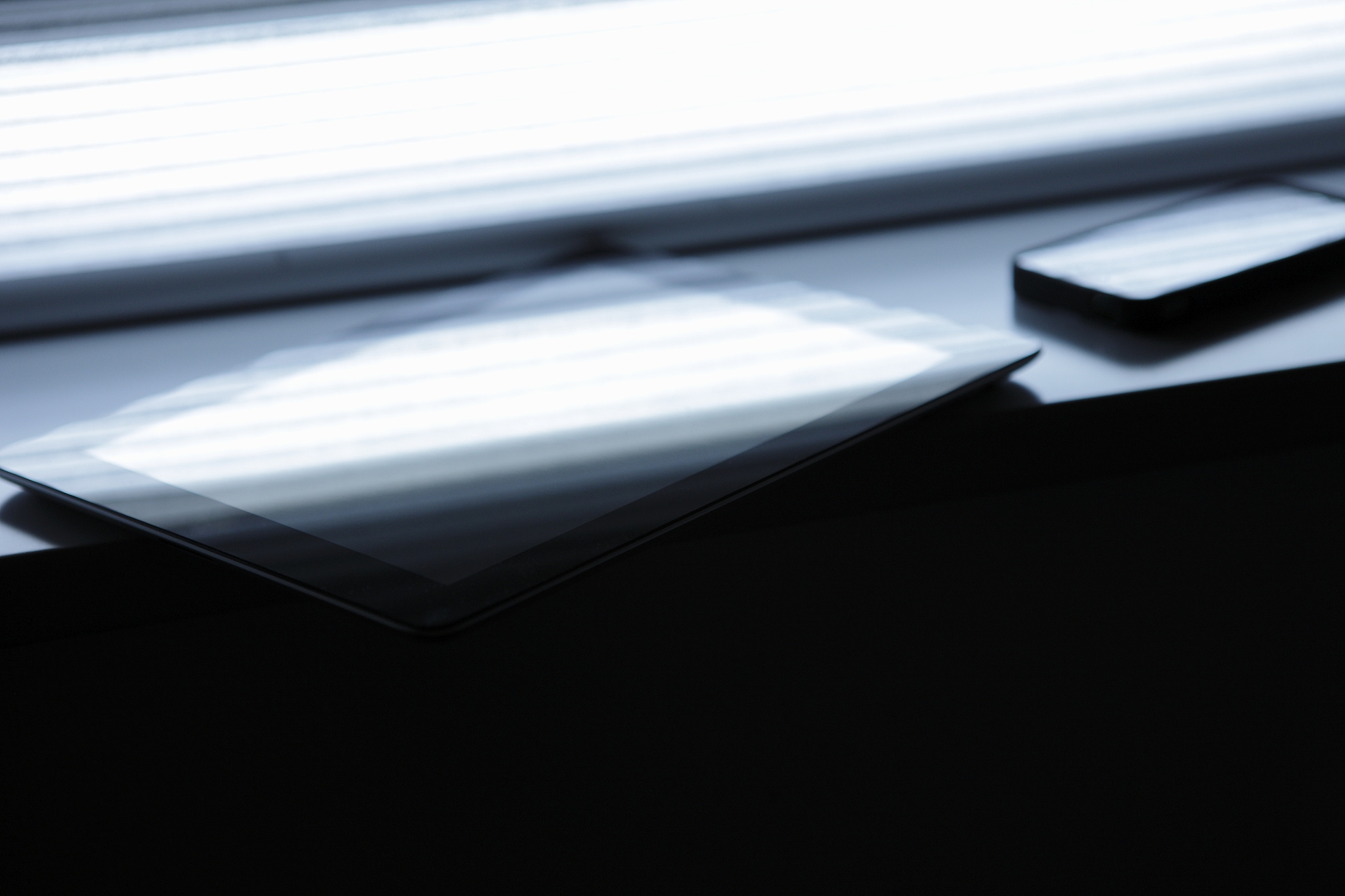 digital tablet and smart phone by the window